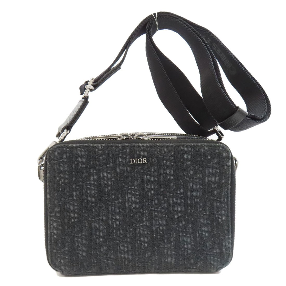 Christian Dior Oblique Shoulder Bag Canvas: Christian Dior Oblique Shoulder Bag Canvas Black canvas shoulder bag with an oblique shoulder design from CHRISTIAN DIOR. This classic style features a timeless silhouette and a simple, elegant