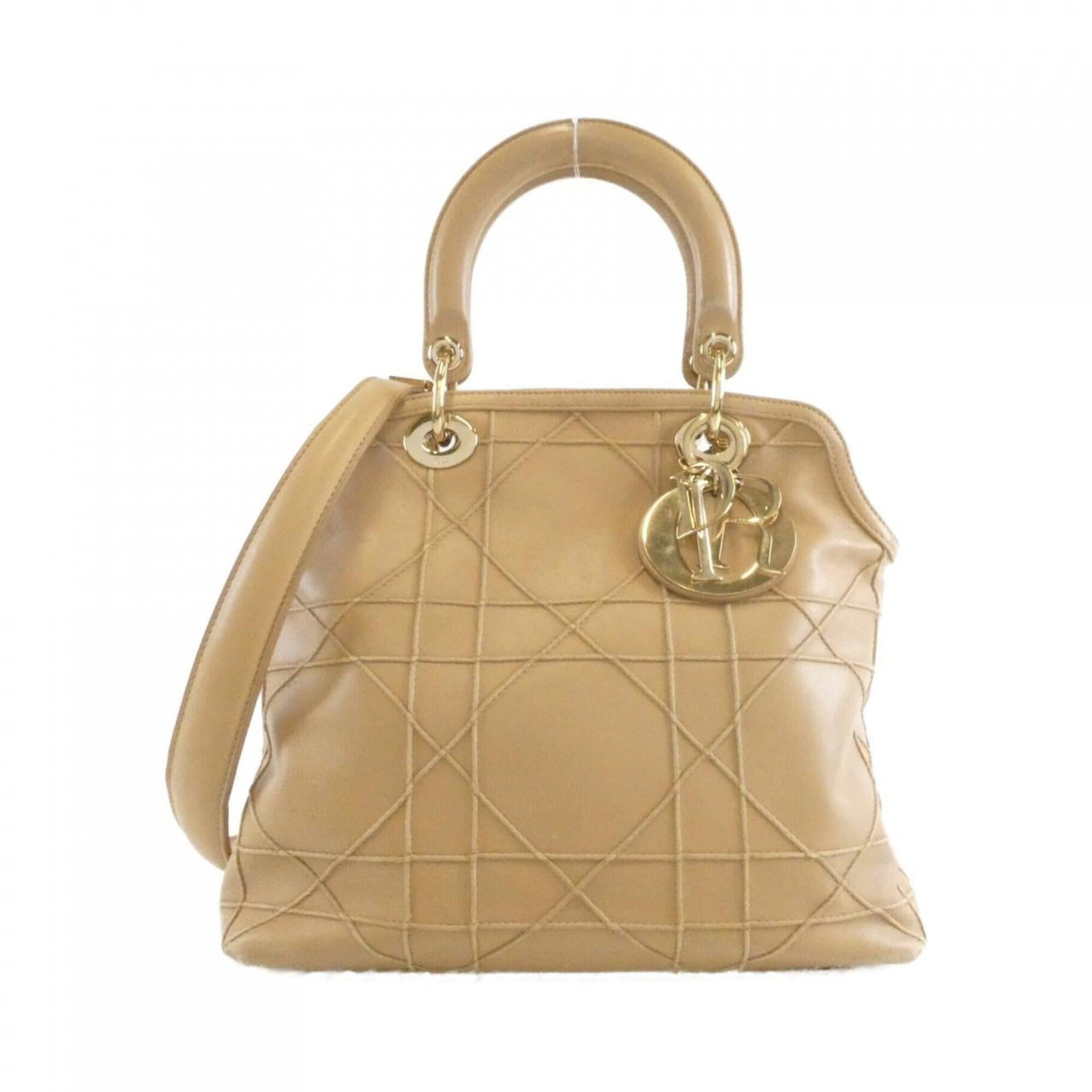 Handbag Christian Dior Leather: Handbag Christian Dior Leather Christian Dior's iconic handbag boasts a timeless design, crafted from high-quality leather in a classic beige hue. The bag features a sturdy strap closure and measures 