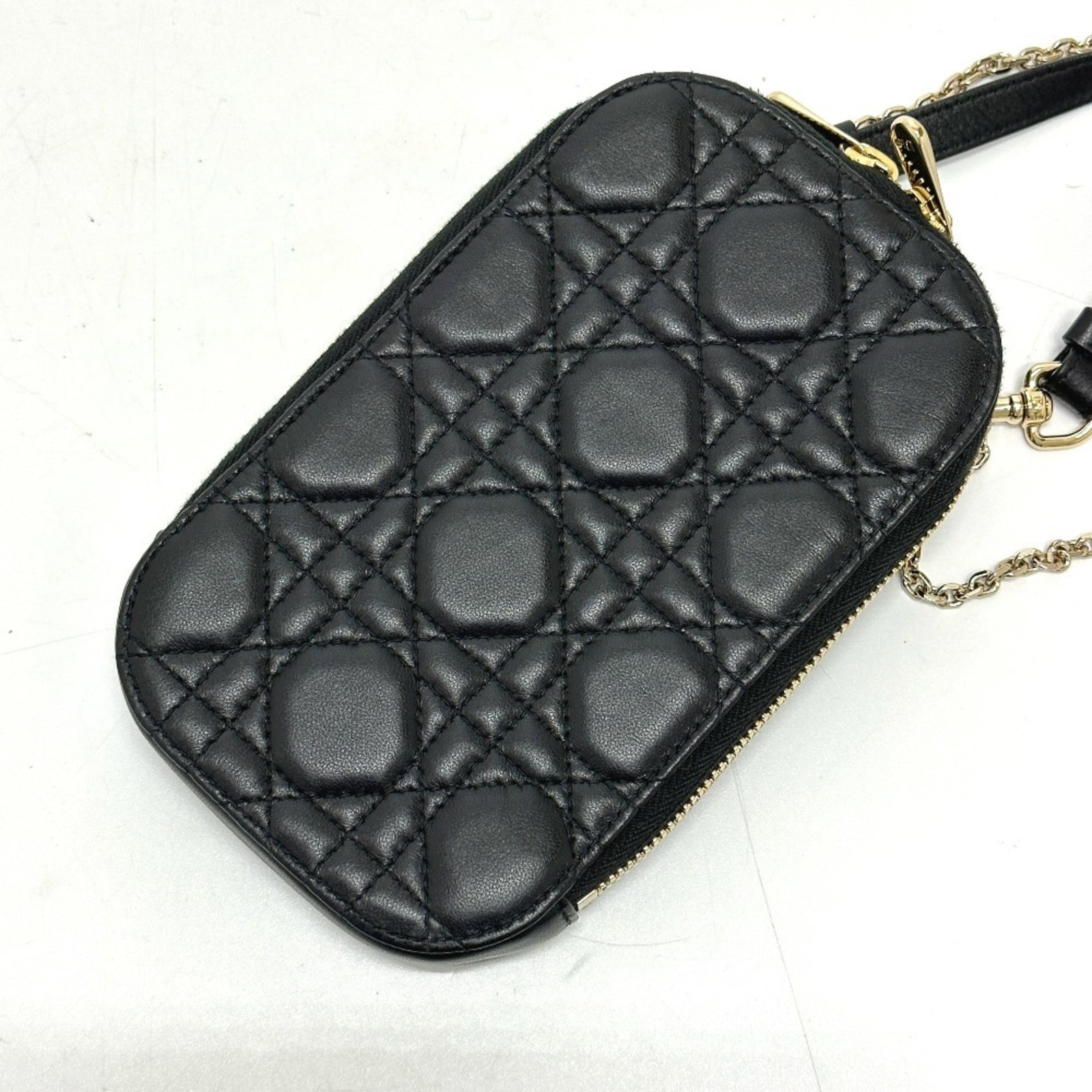 Shoulder bag leather by Christian Dior: Shoulder bag leather by Christian Dior This luxurious Christian Dior Cannage shoulder bag is crafted from high-quality black leather, adorned with gold hardware and featuring a sleek zipper closure.