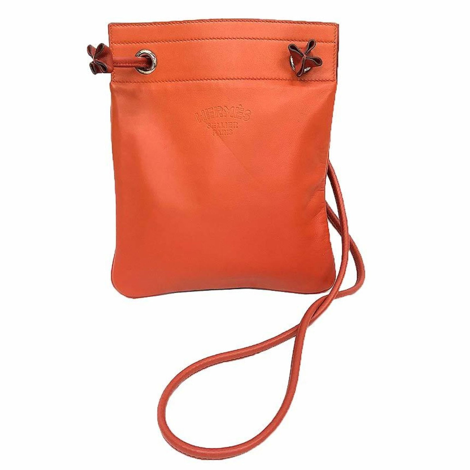 Shoulder Bag Leather Pochette Hermes: Shoulder Bag Leather Pochette Hermes Calfskin and Lambskin Leather Pochette from Hermes, crafted in France with an orange hue. This 23cm x 19cm x 1cm shoulder bag features a classic design with premiu