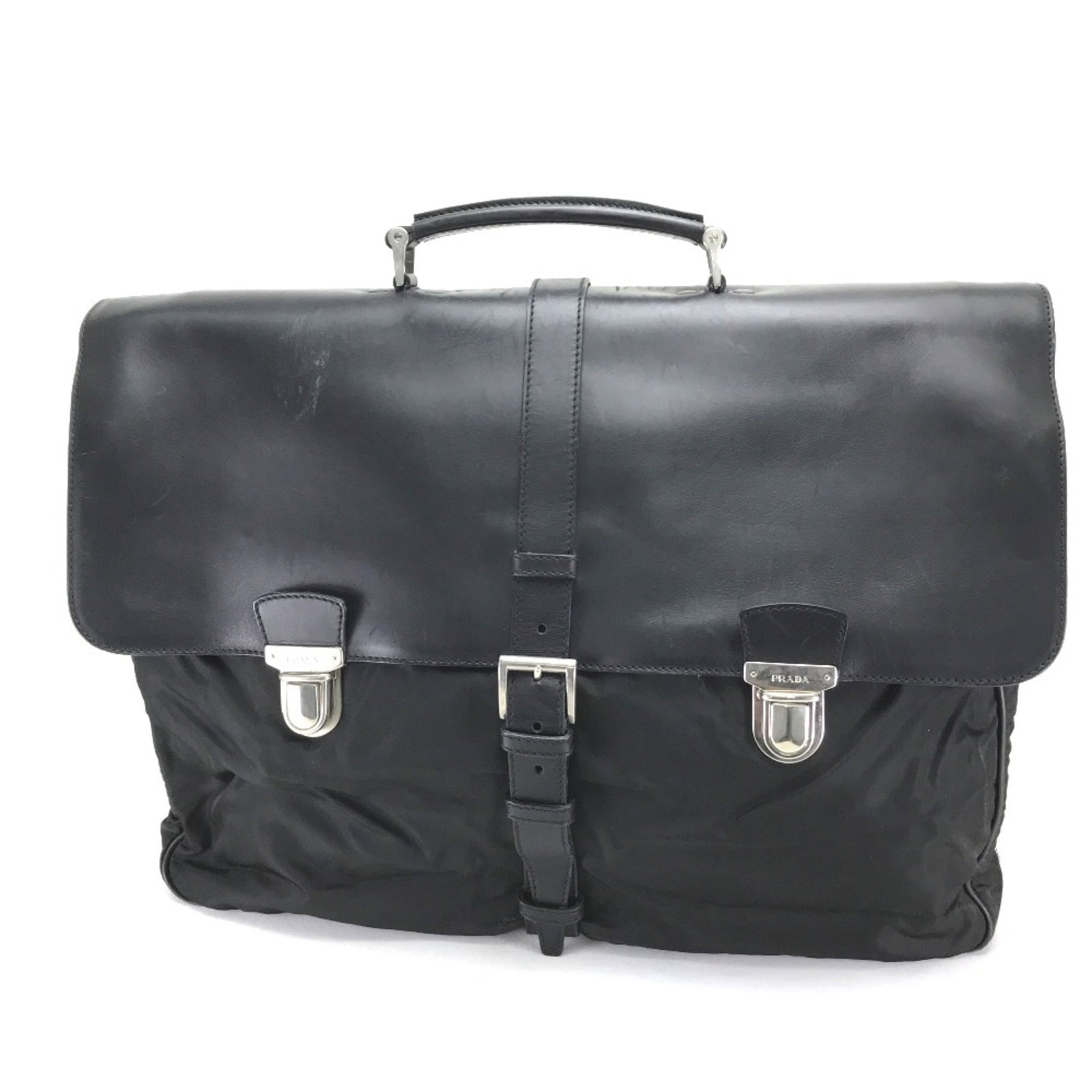 Nylon Leather Handbag Prada: Nylon Leather Handbag Prada Nylon and leather combine in a sleek design, defining this Prada handbag. The black color provides a versatile backdrop for everyday use. A guarantee card accompanies the