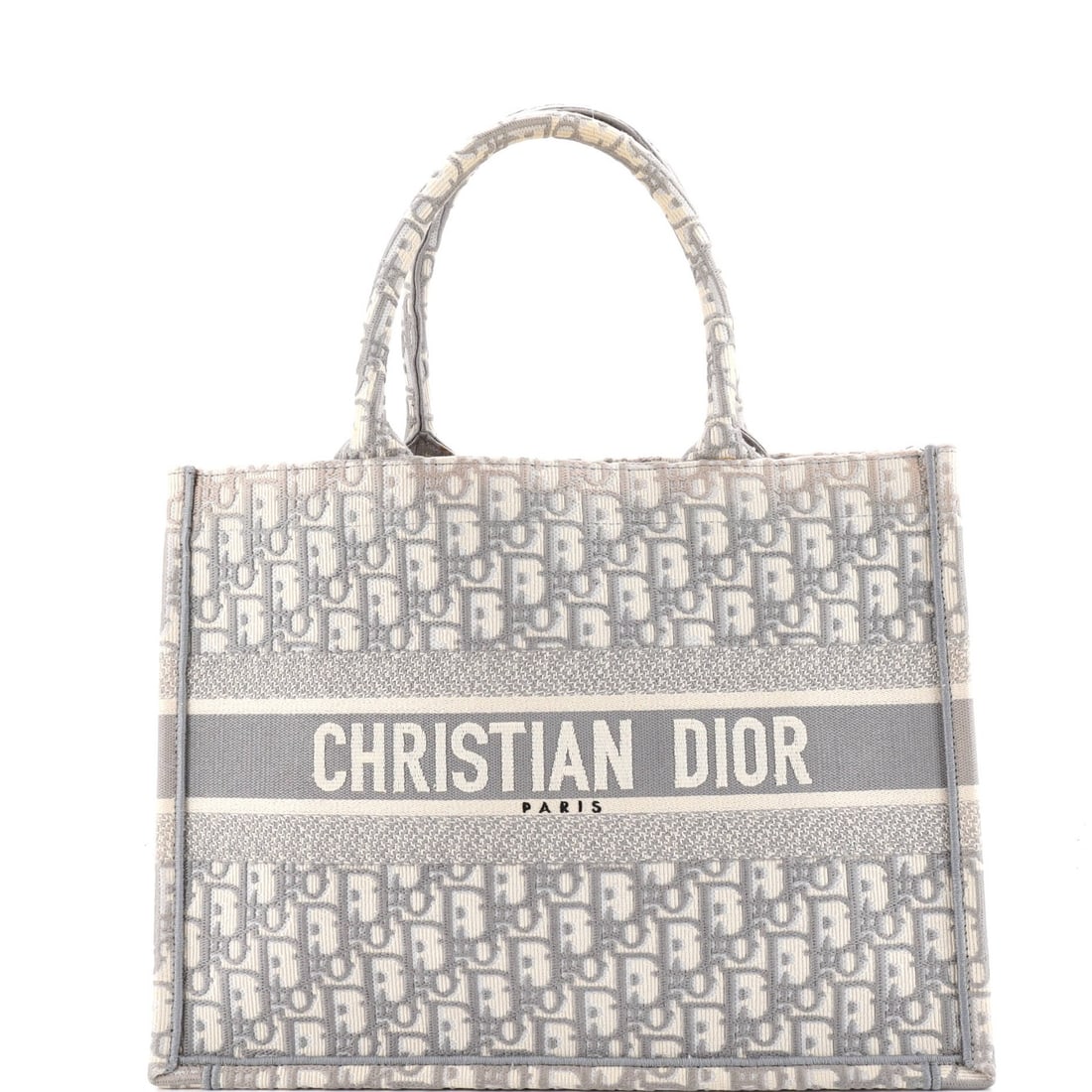 Christian Dior Book Oblique Medium Canvas Tote: Christian Dior Book Oblique Medium Canvas Tote Gray canvas medium Book Oblique Tote from Christian Dior features a classic design with a subtle oblique shape. The exterior shows signs of heavy