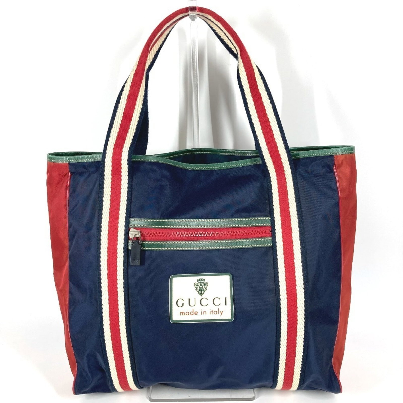 Shoulder bag nylon tote from Gucci: Shoulder bag nylon tote from Gucci Navy and red color options available, this Gucci nylon tote features a classic shoulder bag design with a 33cm x 43cm x 11cm size. Made from high-quality nylon mater