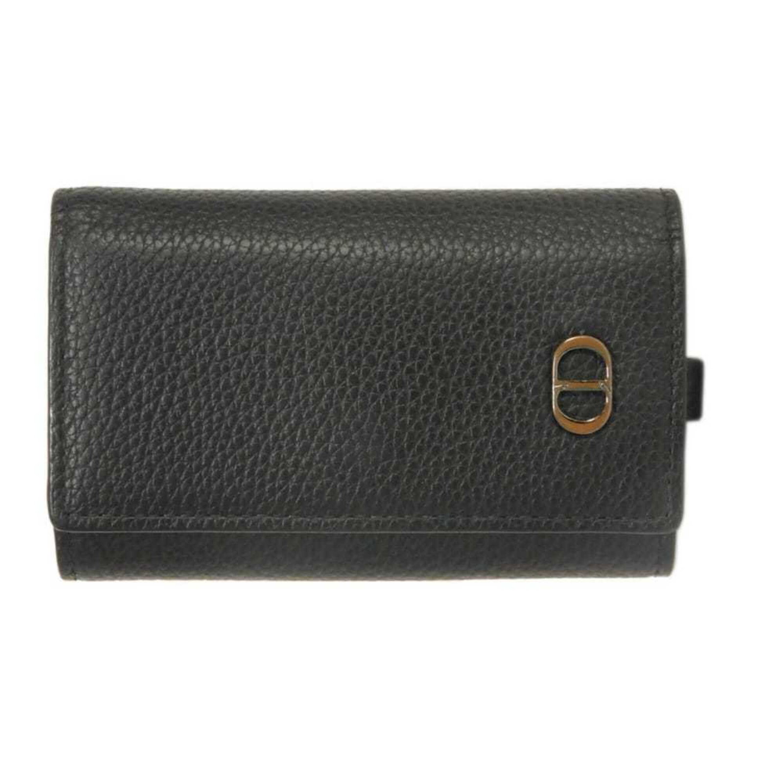 Keyring Leather by Christian Dior: Keyring Leather by Christian Dior Christian Dior's Keyring Leather boasts sleek, black calfskin craftsmanship. The compact design measures 10.5cm x 6.8cm x 2.3cm, making it a convenient accessory for 