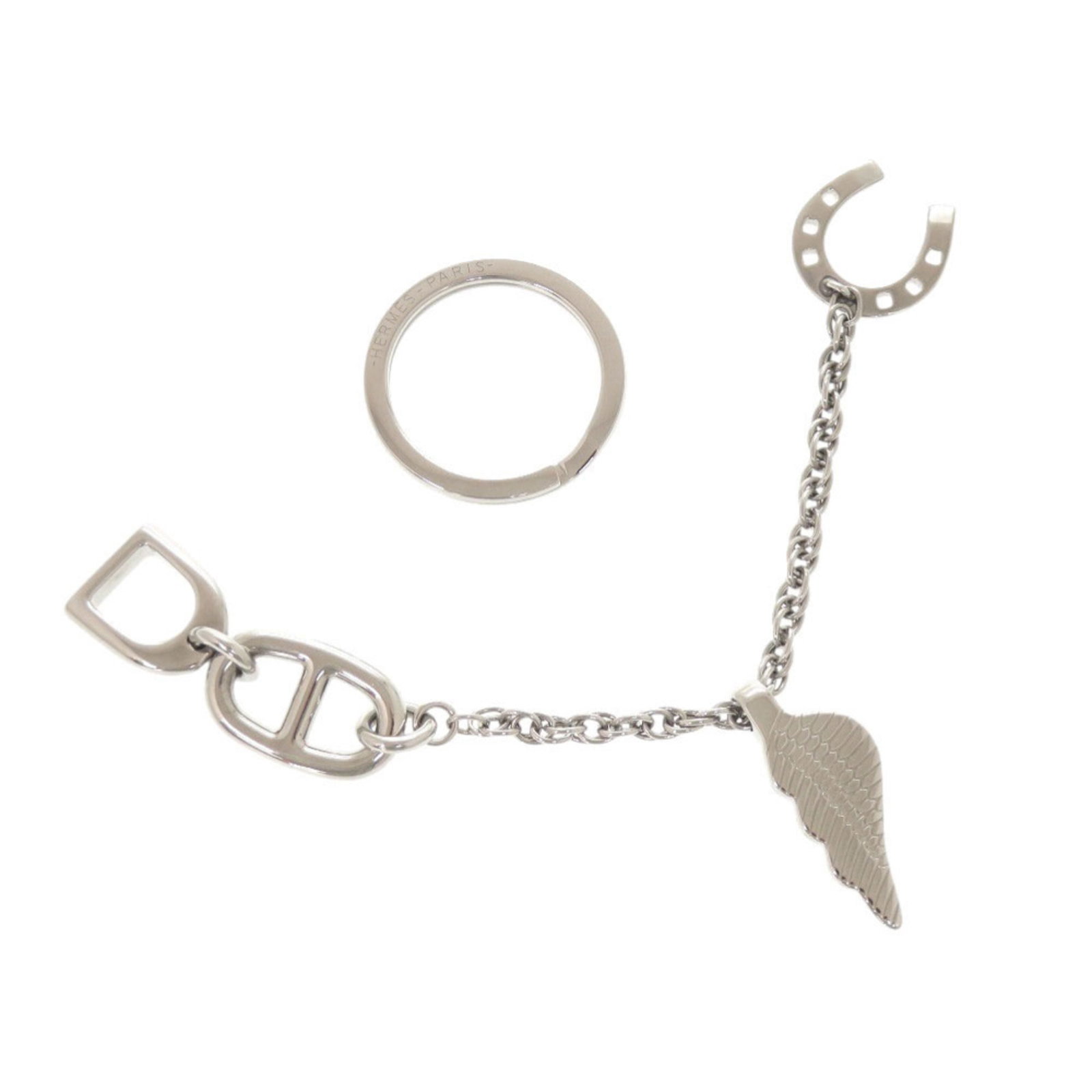 Keyring Metal By Hermes: Keyring Metal By Hermes Silver metal keyring from the renowned Swiss brand Hermes, beautifully packaged in a box. A sleek and elegant accessory for everyday use, this keyring showcases the timeless st