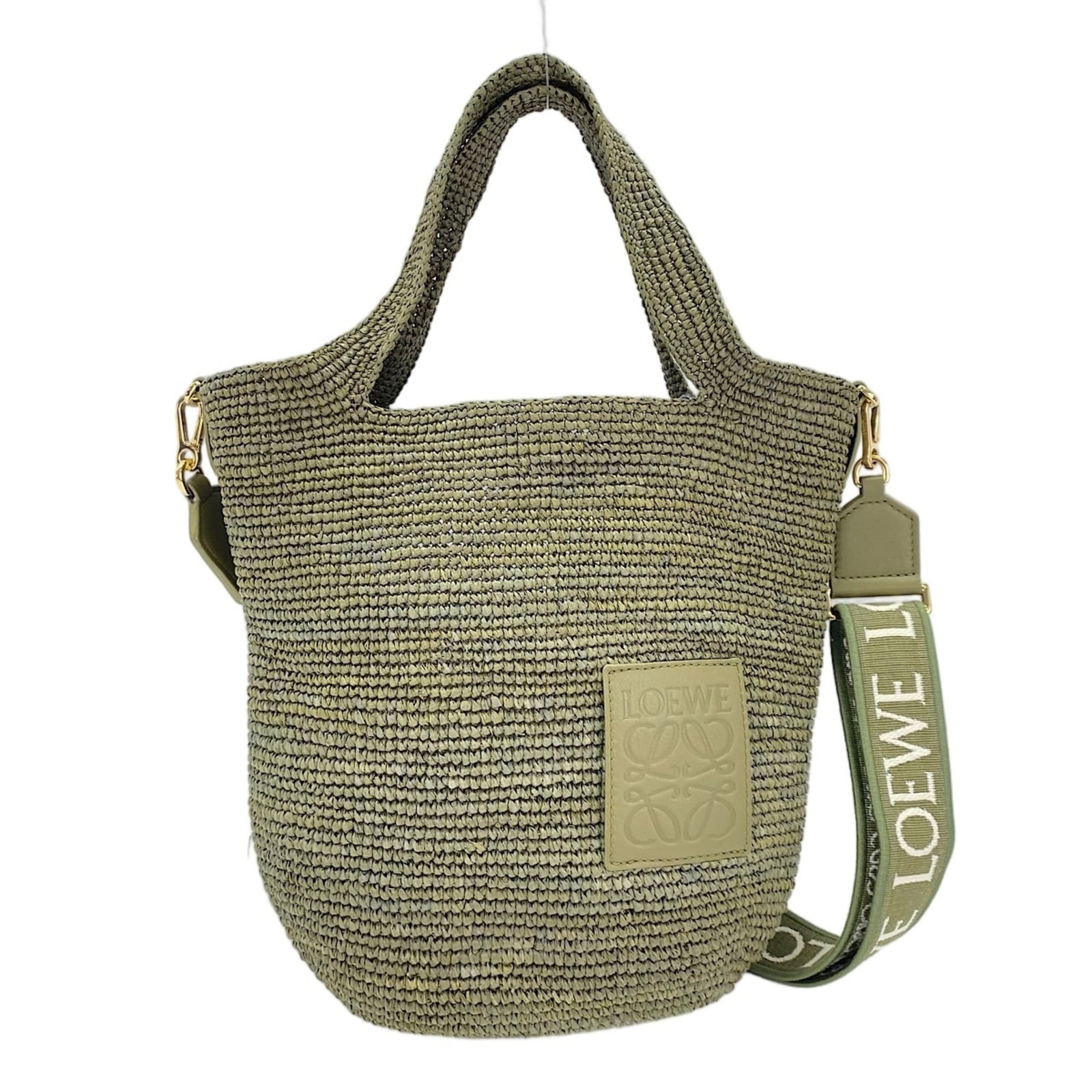Handbag by Loewe: Handbag by Loewe Loewe's iconic handbag boasts a striking green hue, measuring 30cm x 30cm x 10cm. With its sleek design and compact size, this stylish accessory is perfect for everyday use. The bag b