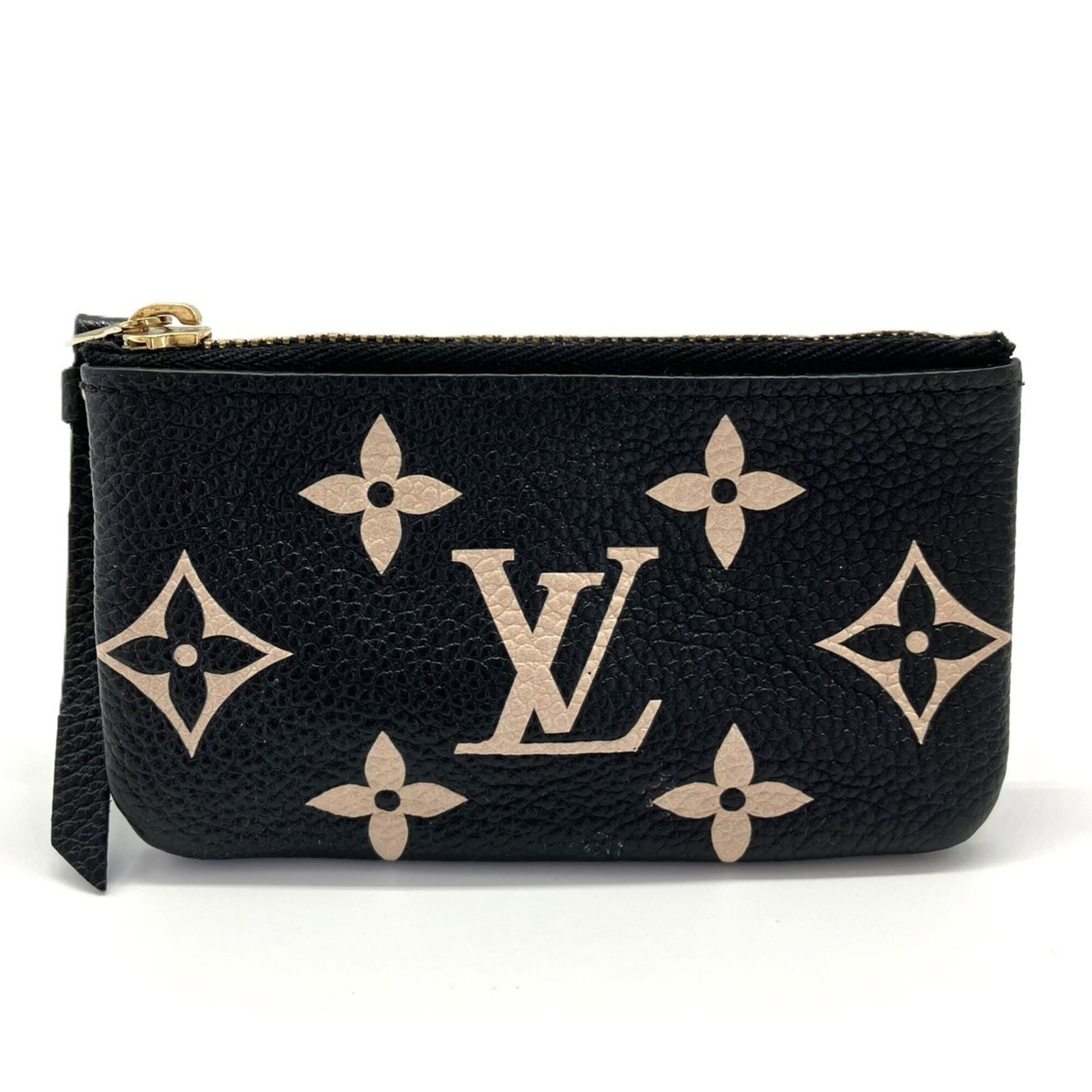 Pouch Monogram Empreinte Louis Vuitton: Pouch Monogram Empreinte Louis Vuitton Monogram Empreinte Louis Vuitton Pouch in Beige and Black. This stylish pouch features the iconic Monogram Empreinte pattern, a signature design element of the