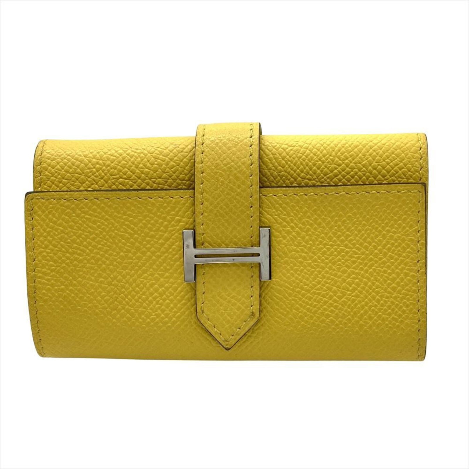 Hermes Keycase Epsom Leather: Hermes Keycase Epsom Leather Yellow Epsom leather keycase from Hermes, measuring 6.5cm x 10.5cm x 2cm. This compact case is crafted from high-quality Epsom leather, a signature material for the French