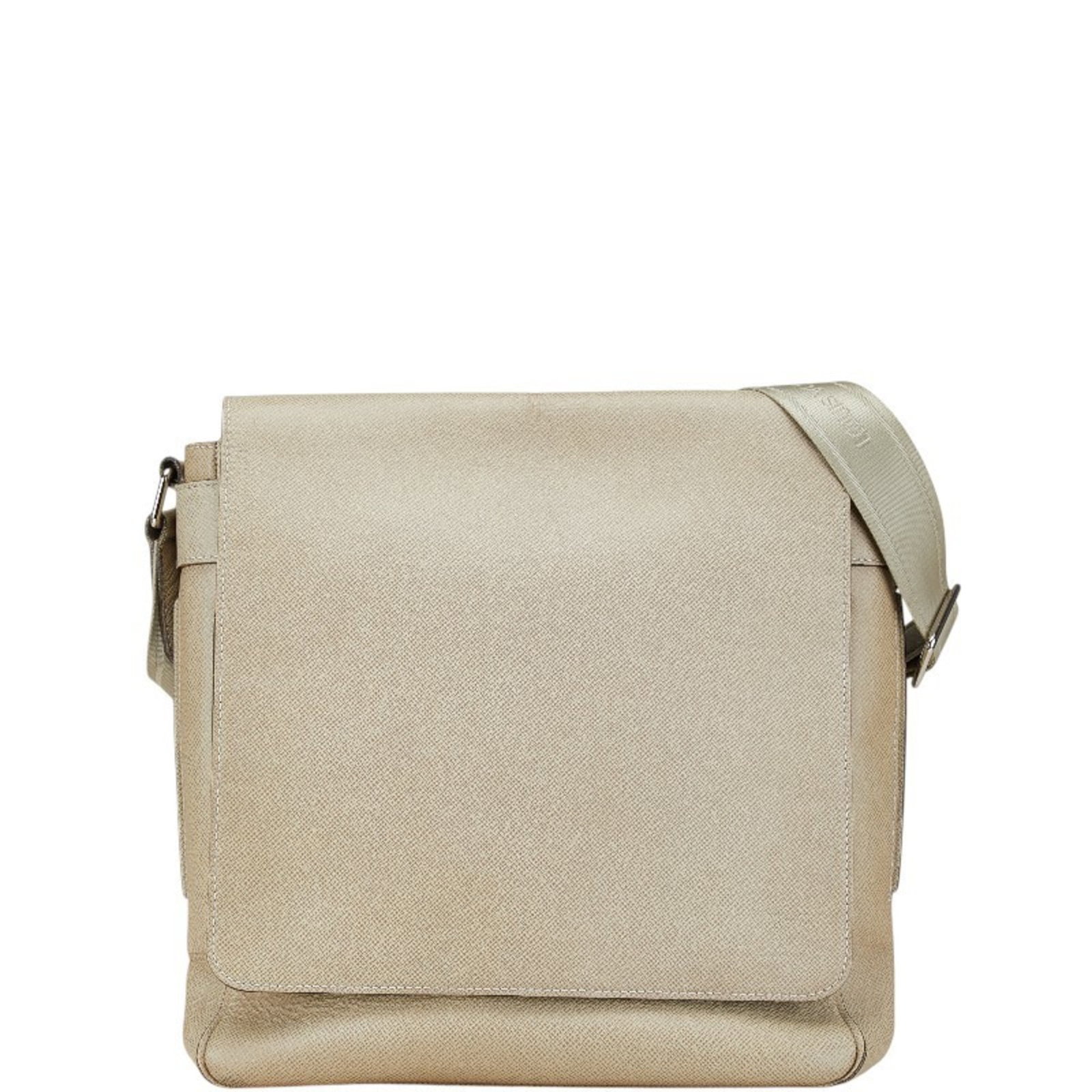 Taiga Leather Shoulder Bag by Louis Vuitton: Taiga Leather Shoulder Bag by Louis Vuitton Taiga Leather Shoulder Bag by Louis Vuitton boasts a timeless design with its beige, Polaire color and sleek magnet closure. The bag features two practical