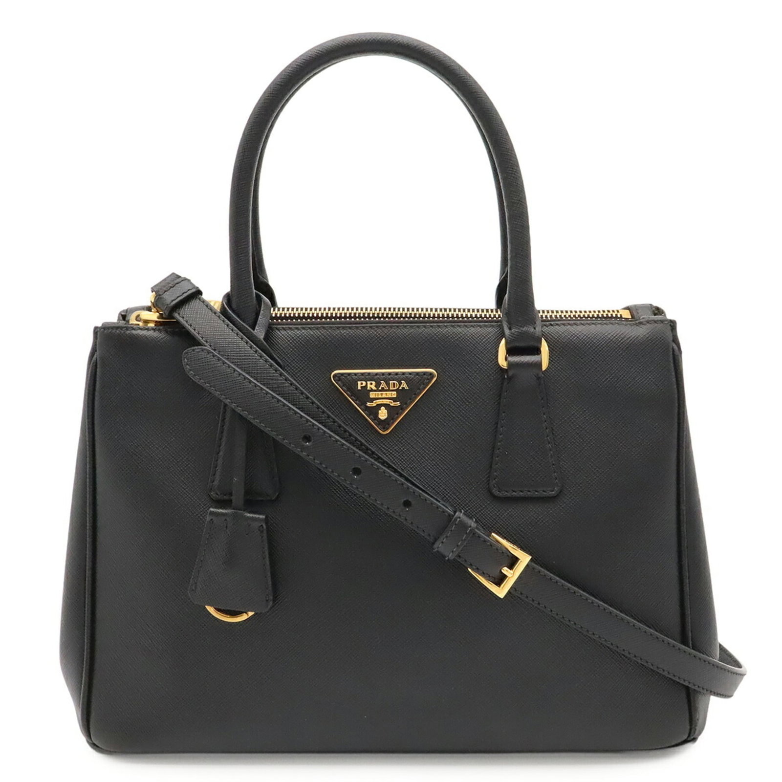 Handbag Saffiano by Prada: Handbag Saffiano by Prada Saffiano leather construction provides durability and style to this sleek black Prada handbag, measuring 20cm x 29.5cm x 13cm in size. The classic design features a timeless 