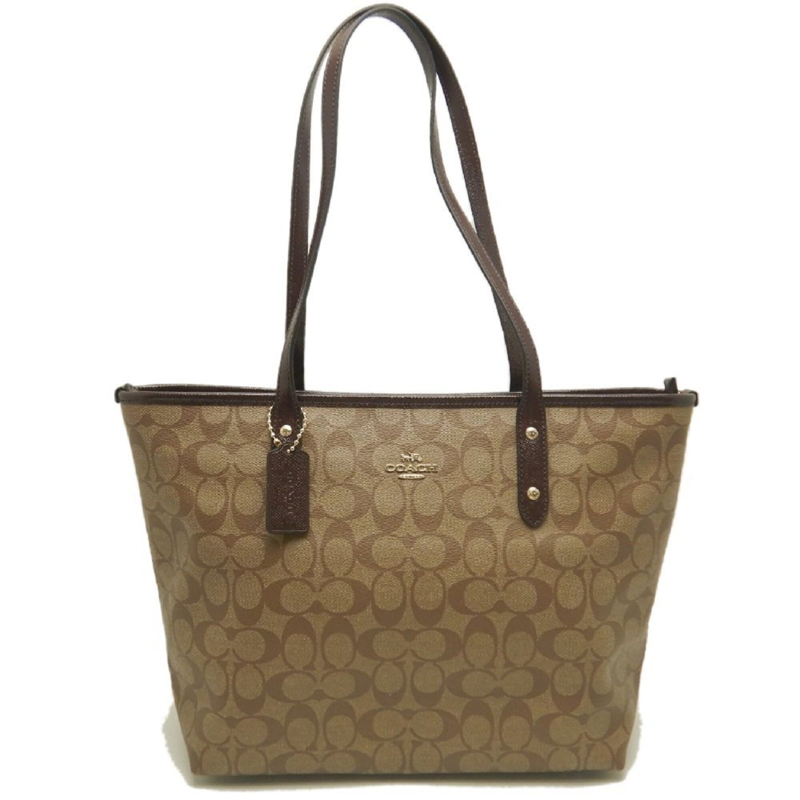 Canvas Coated Tote Bag By: Canvas Coated Tote Bag By Coated canvas construction provides durability and style, while the beige color offers a versatile neutral tone. The gold hardware adds a touch of sophistication to this