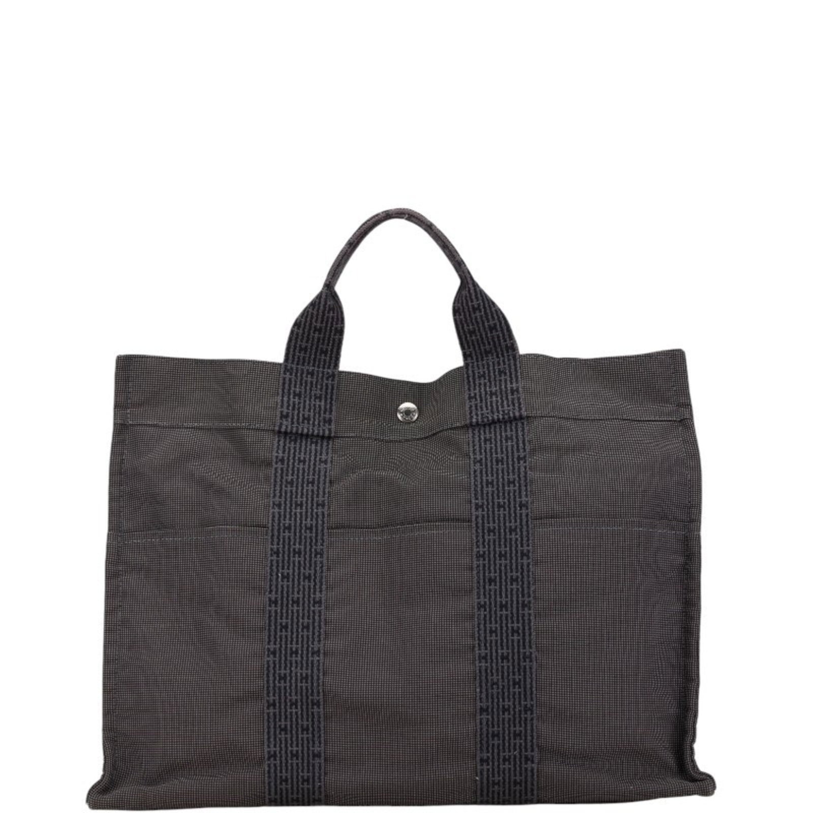 Canvas Hermes Tote Bag: Canvas Hermes Tote Bag Gray canvas tote bag from Hermes, measuring 33cm x 41cm x 10cm. This classic design showcases the brand's signature style and timeless appeal. A versatile accessory for