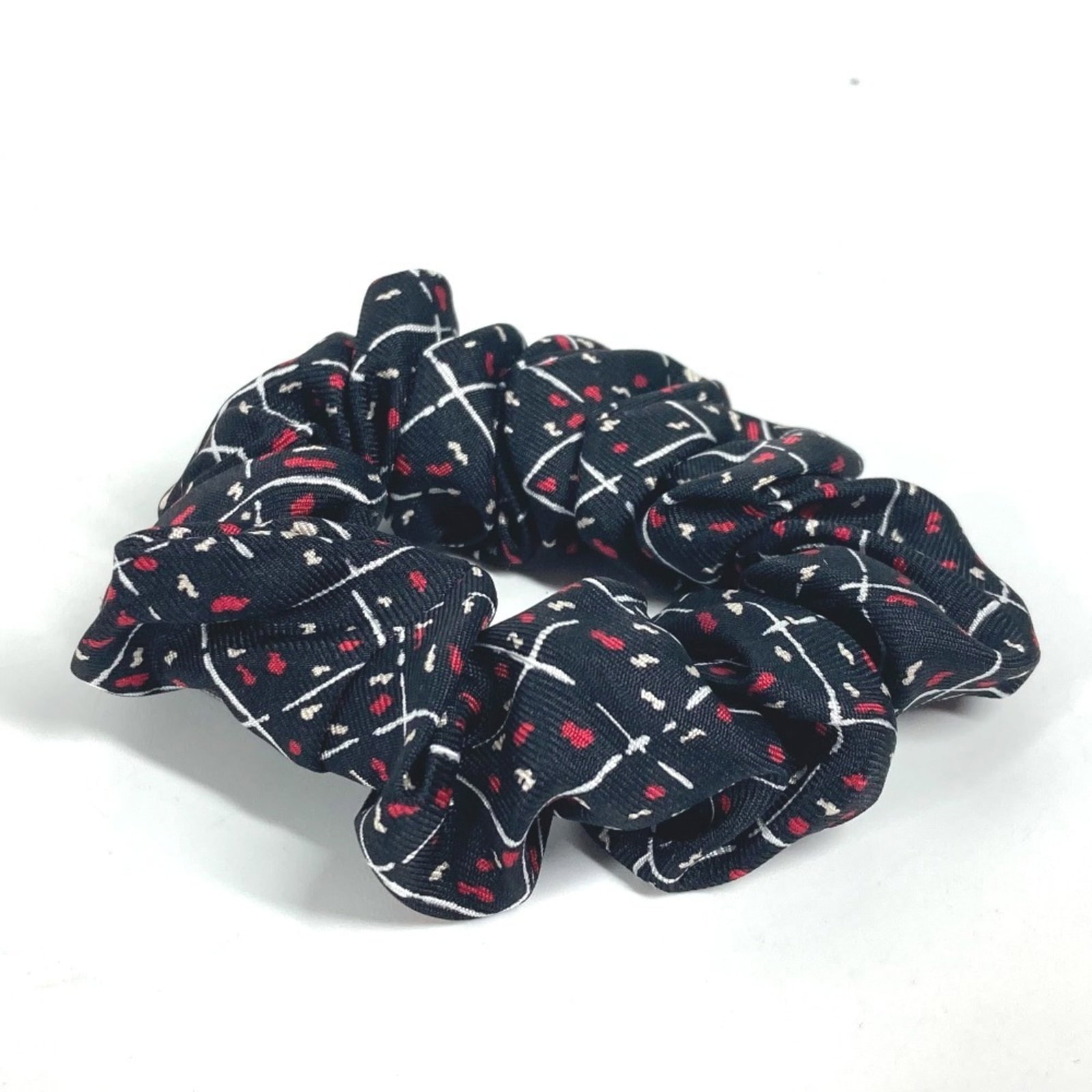 Silk hair tie by Chanel: Silk hair tie by Chanel Silk hair tie by Chanel, featuring a sleek black design. Made from high-quality silk, this elegant accessory adds a touch of sophistication to any hairstyle. Its classic style