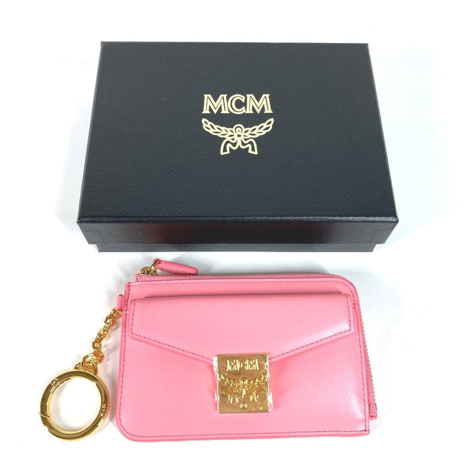 Mcm Coin Purse/ Coin Case Leather: Mcm Coin Purse/ Coin Case Leather Pink leather coin purse/coin case with a compact size of 8cm x 12cm. Comes in a box and dust bag for storage, making it a practical accessory. A stylish addition to