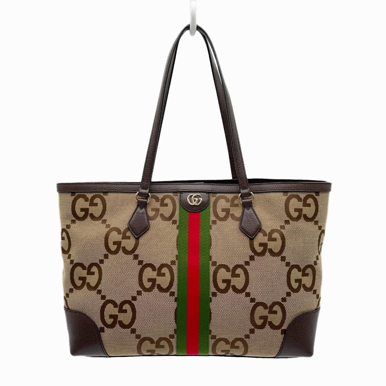 Canvas leather tote bag by Gucci: Canvas leather tote bag by Gucci Canvas leather tote bag by Gucci, featuring a sturdy canvas exterior and premium leather accents in rich brown. Measuring 27cm x 37.5cm x 13.5cm, this stylish tote