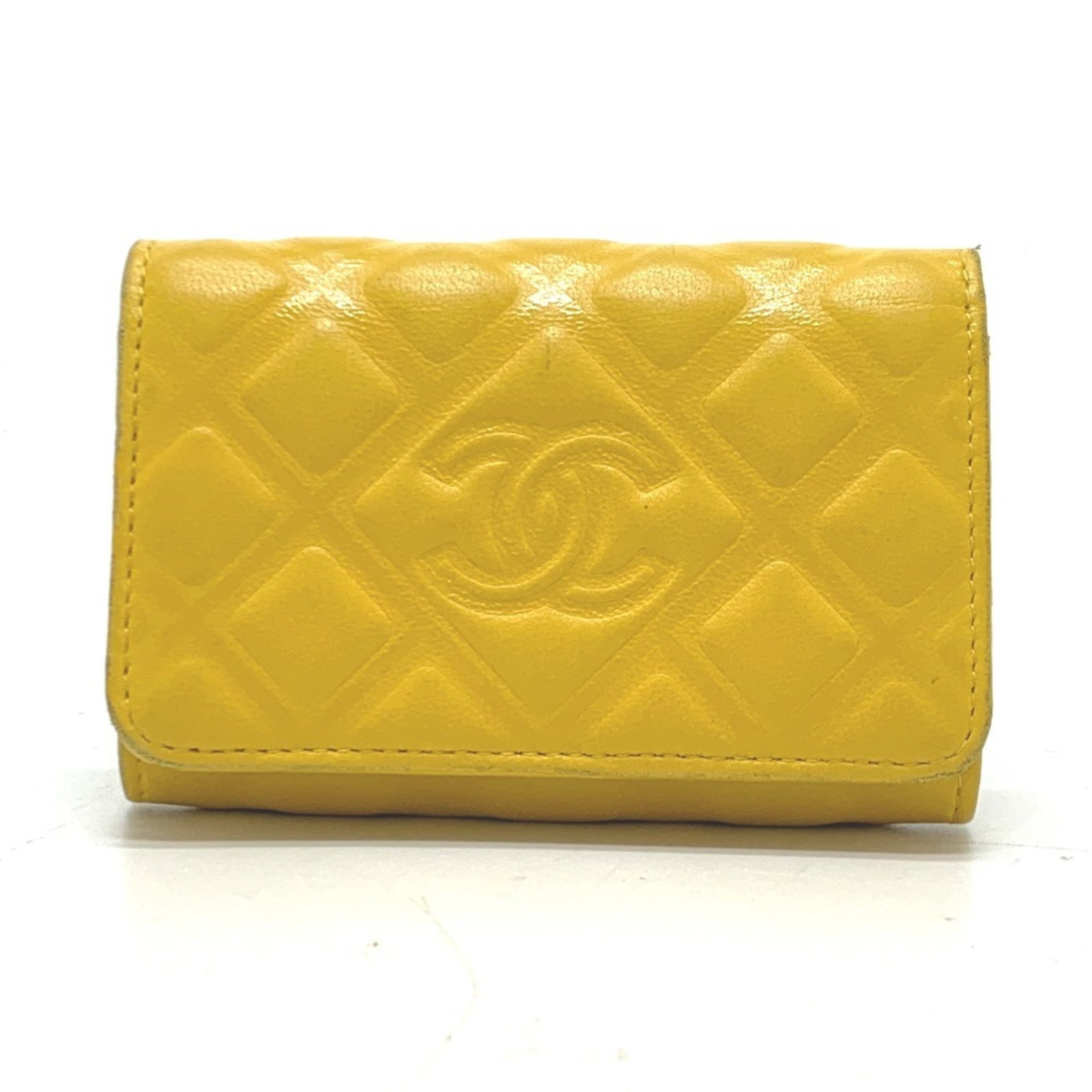 Keyring Leather by Chanel: Keyring Leather by Chanel Keyring Leather by Chanel boasts a vibrant yellow hue, adding a pop of color to any keychain. Crafted from high-quality calfskin leather, this elegant accessory measures