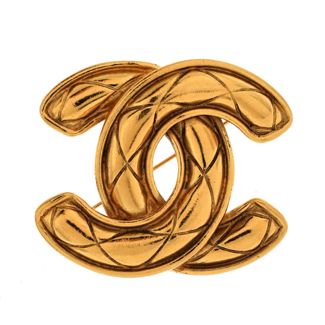 Quilted Vintage CC Metal Chanel Brooch: Quilted Vintage CC Metal Chanel Brooch Quilted CC metal brooch in gold, measuring 1.9" tall and 2.2" wide, with scratches, tarnish, and minor dings throughout. The vintage design bears a signature but