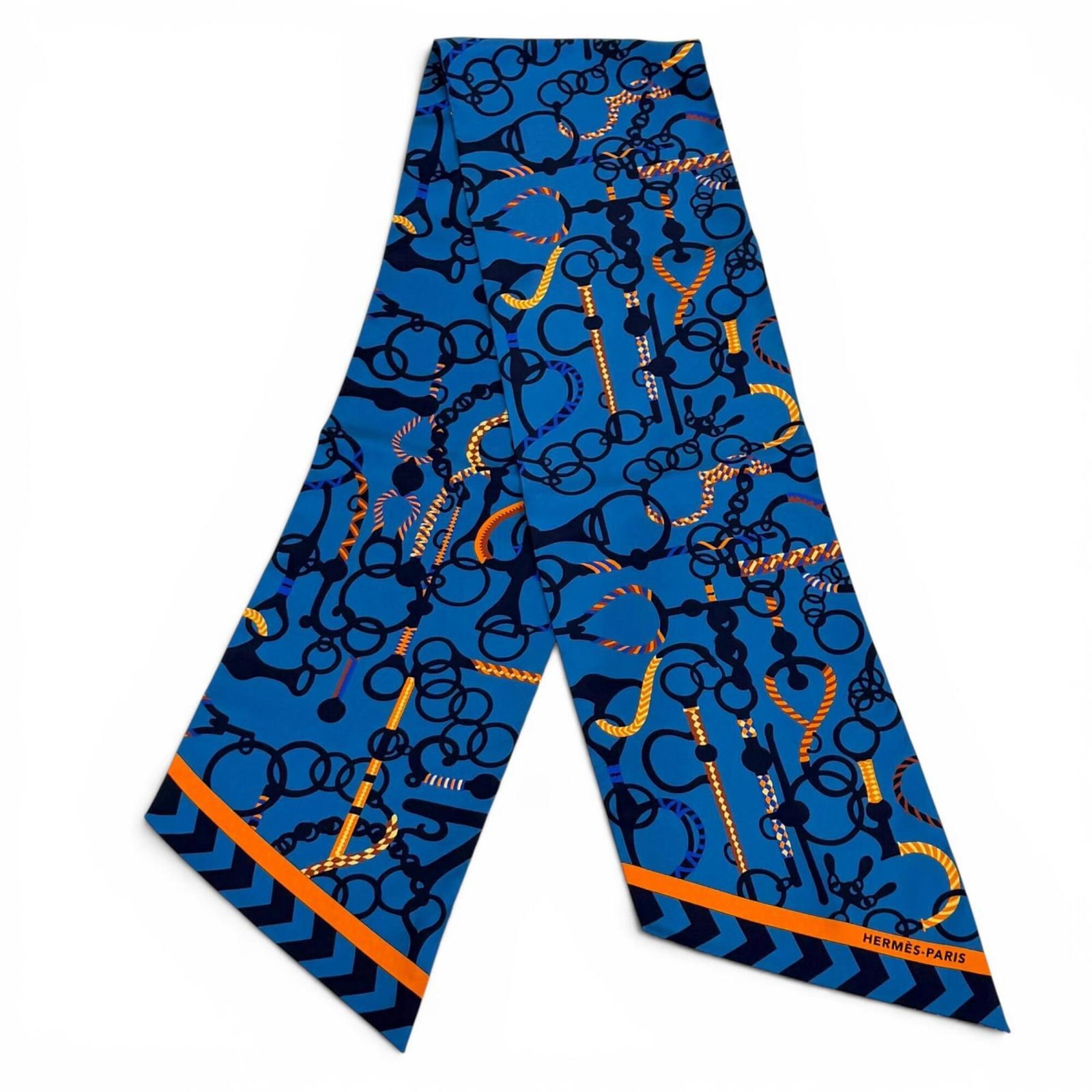 Hermes Silk Scarf: Hermes Silk Scarf Silk scarf from renowned French fashion house Hermes, boasting vibrant blue hue and elegant 20cm width. Measuring 1.56m in length, this luxurious silk accessory is a stylish