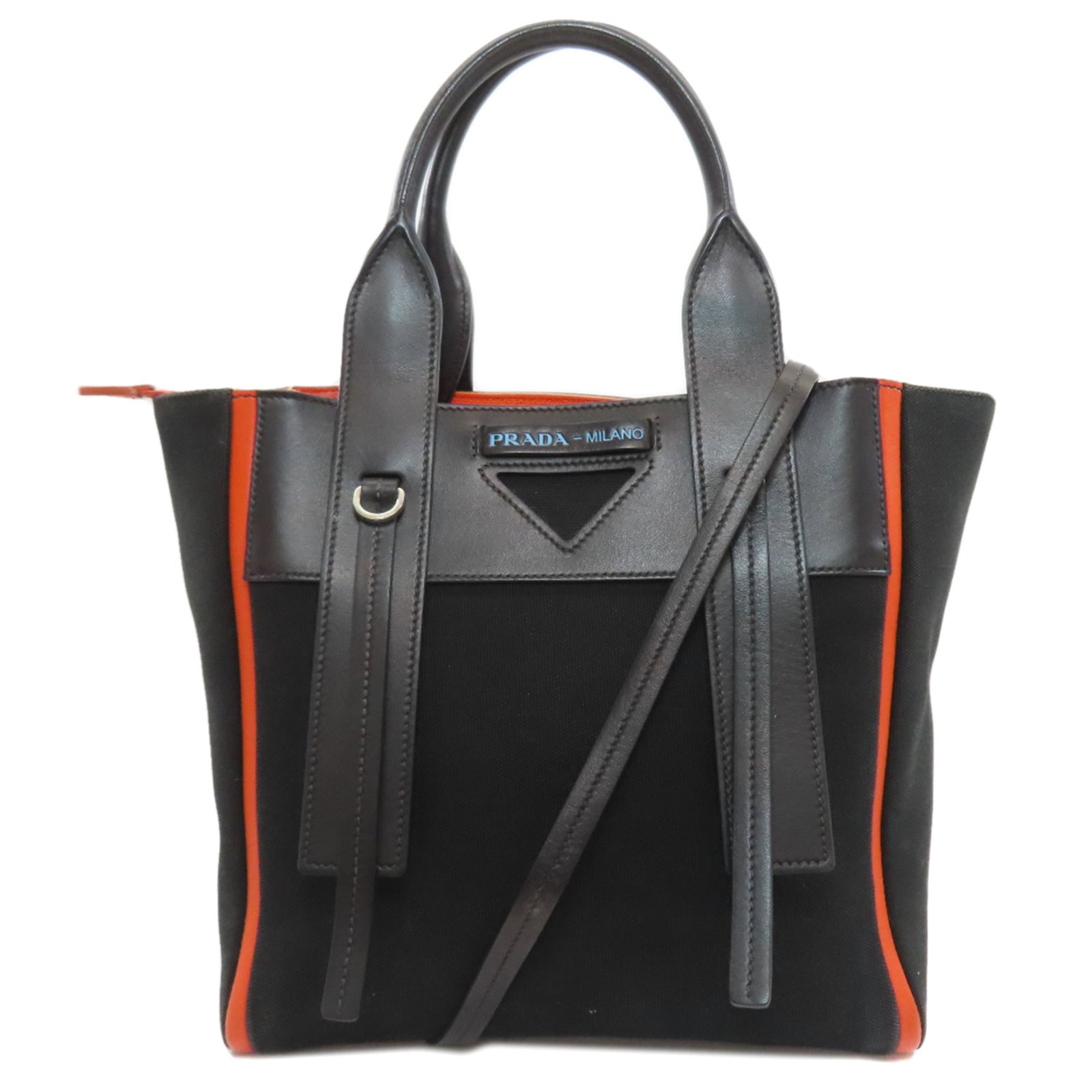 Handbag Canvas by Prada: Handbag Canvas by Prada Canvas by Prada, an iconic handbag made from canvas material in vibrant orange. Measuring 24cm x 33cm x 11.5cm, it boasts a unique size and shape that sets it apart. This