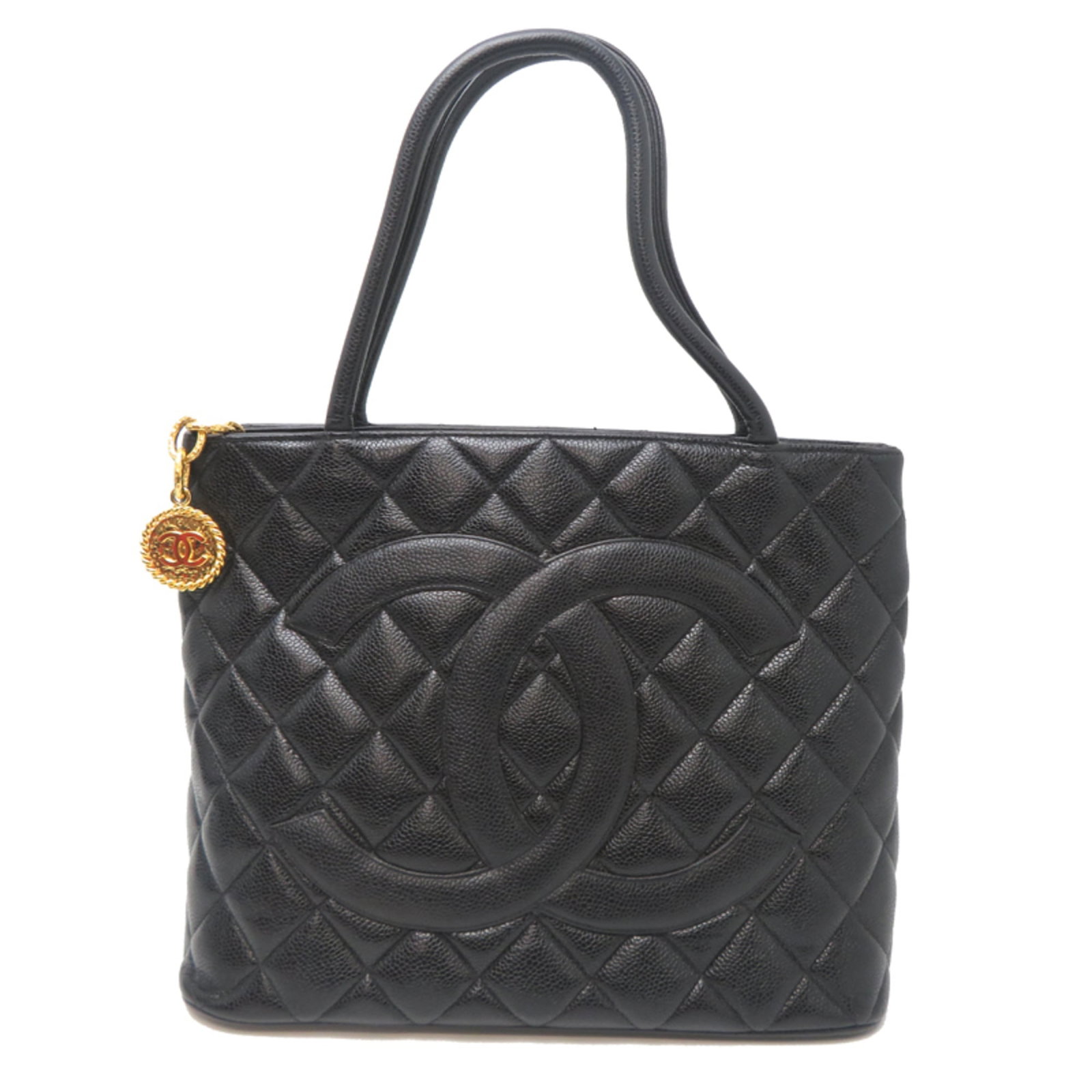 Calfskin Handbag by Chanel: Calfskin Handbag by Chanel Calfskin Handbag by Chanel features a sleek, black design made from high-quality grained calfskin. The bag's classic style and timeless elegance make it a stylish accessory