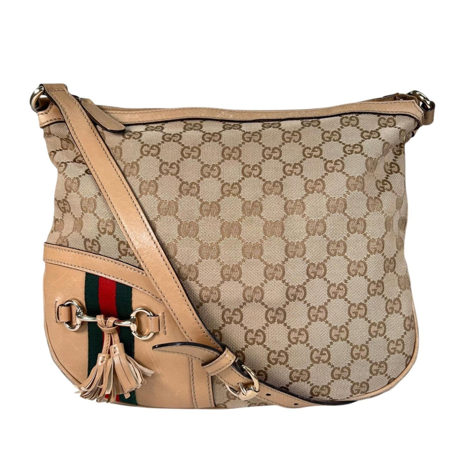 Shoulder Bag Canvas Gucci: Shoulder Bag Canvas Gucci Gucci's iconic GG canvas design takes center stage in this stylish shoulder bag, crafted from high-quality beige material. Measuring 25cm x 33cm x 4cm, the bag boasts a sleek