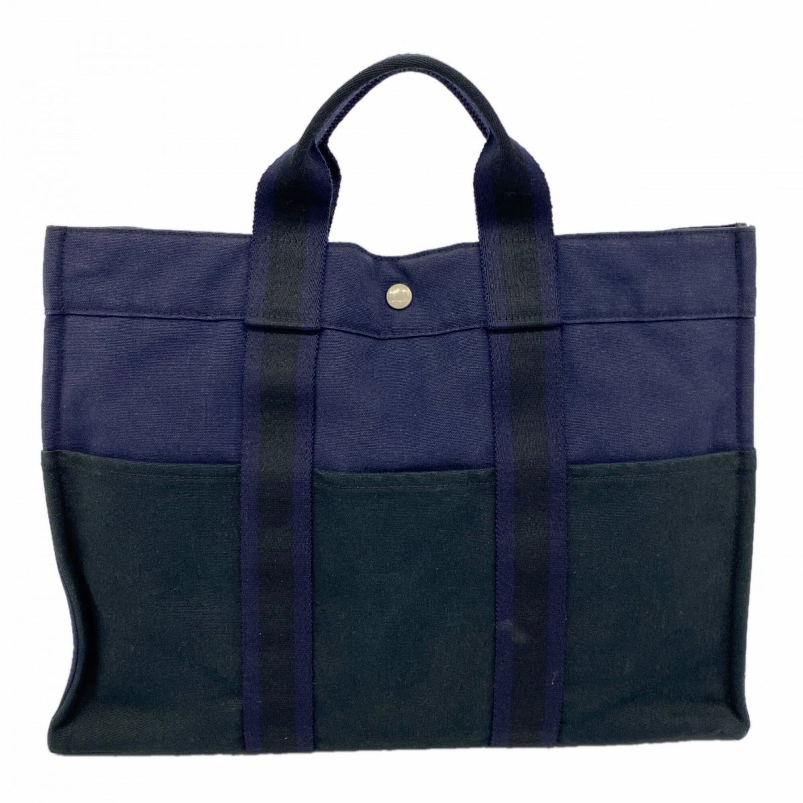 Canvas Hermes Tote Bag: Canvas Hermes Tote Bag Canvas Hermes Tote Bag - A Timeless Classic. Made from high-quality canvas, this iconic tote bag boasts a sleek black and navy color combination with silver hardware details. Me