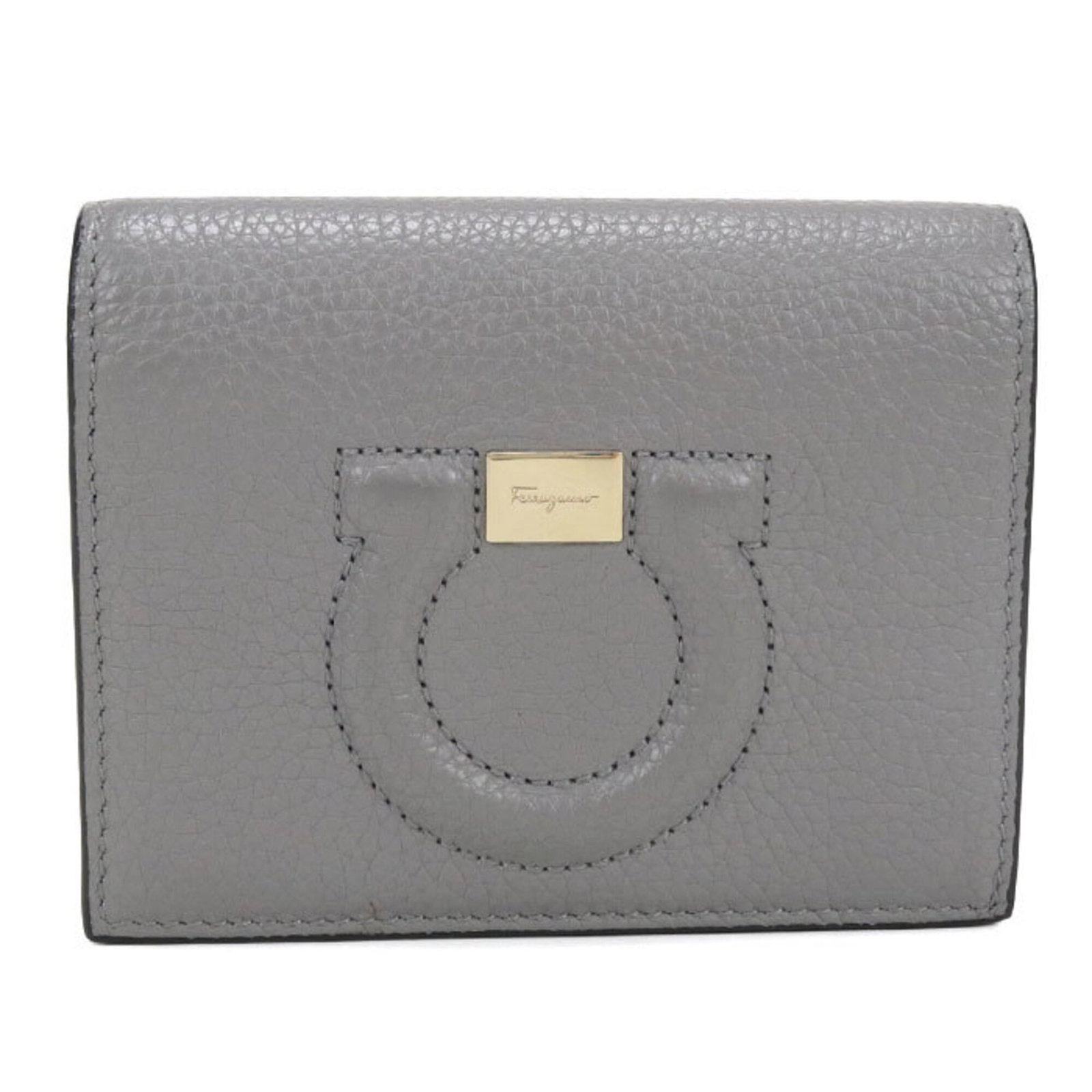 Salvatore Ferragamo Wallet (Bi-Fold) Leather: Salvatore Ferragamo Wallet (Bi-Fold) Leather Salvatore Ferragamo's iconic bi-fold wallet features high-quality calfskin leather in a sleek gray color. Made in Italy, this stylish accessory boasts