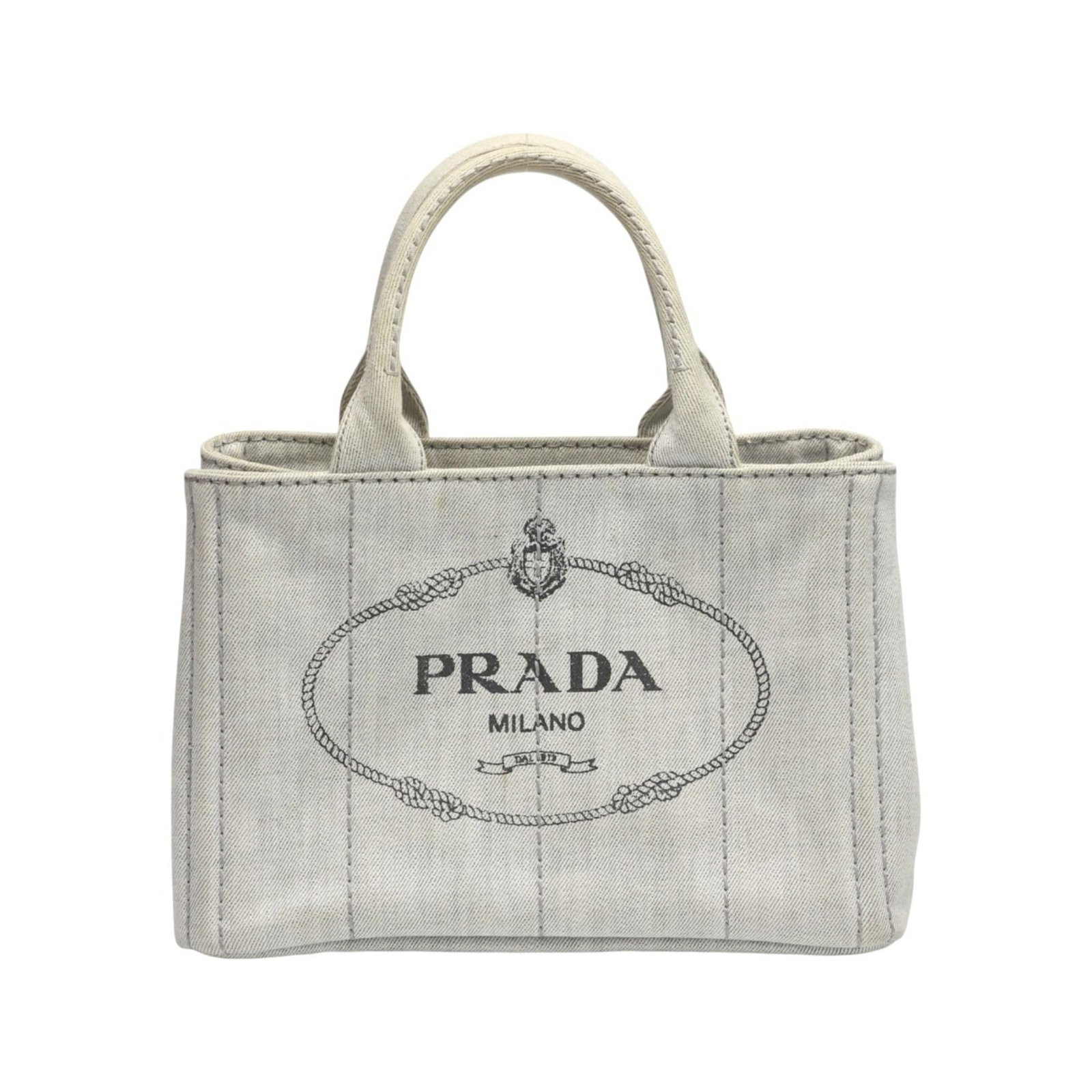 Tote bag canvas by Prada: Tote bag canvas by Prada Prada's canvas tote bag is crafted from high-quality materials, featuring a crisp white finish. The compact size and durable design make it a practical accessory for daily