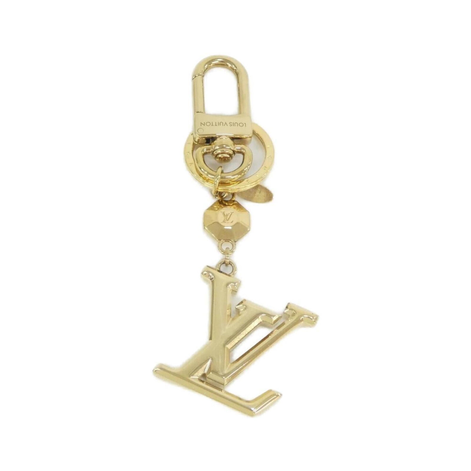 Louis Vuitton Keyring: Louis Vuitton Keyring Gold Keyring by Louis Vuitton. This gold keyring bears the iconic brand's signature style, making it a stylish accessory for everyday use. With its sleek design and luxurious mat