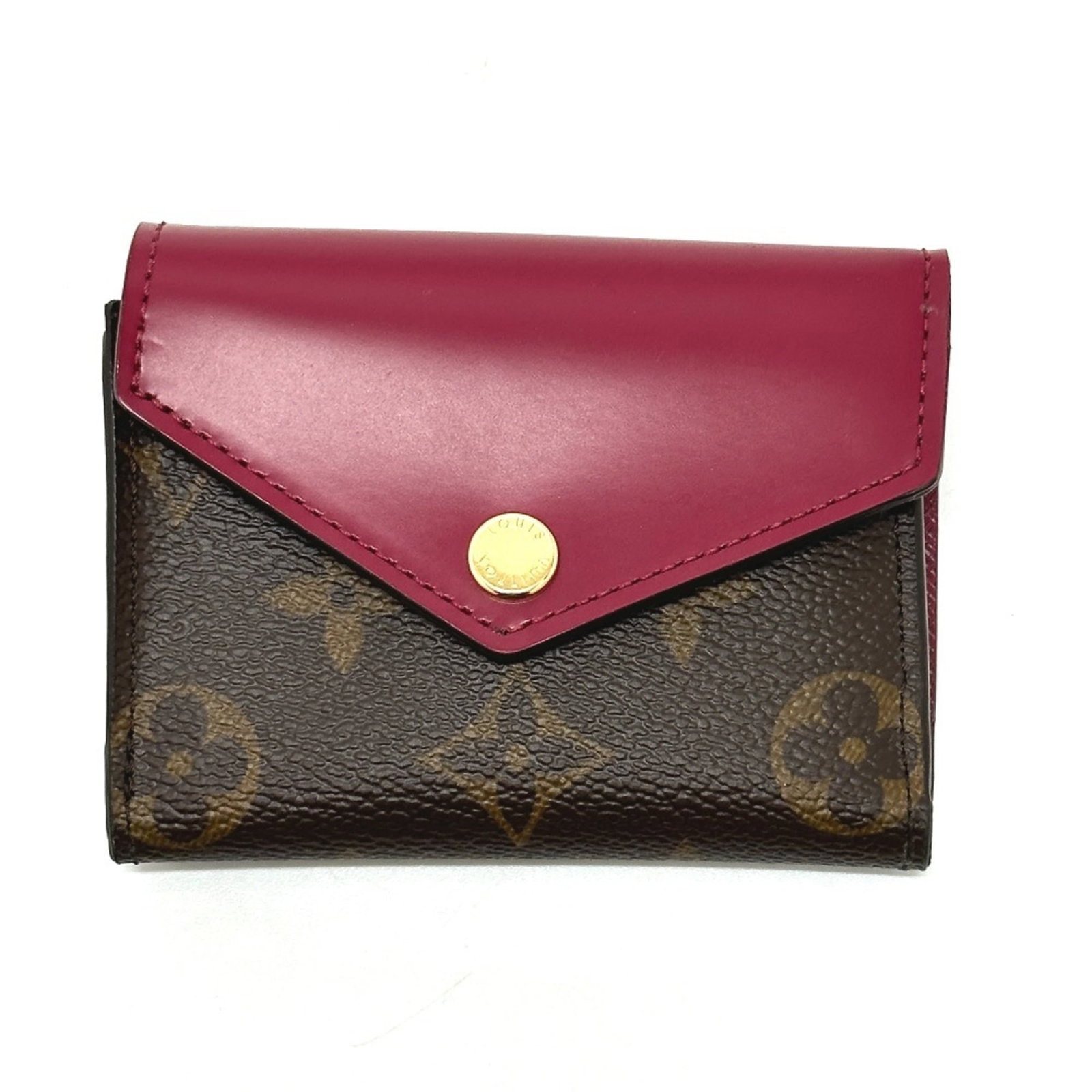 Louis Vuitton Wallet (Tri-Fold) Monogram: Louis Vuitton Wallet (Tri-Fold) Monogram Brown and Fuchsia Monogram Louis Vuitton Tri-Fold Wallet. This classic tri-fold wallet from the iconic French brand features the signature monogram pattern, a 