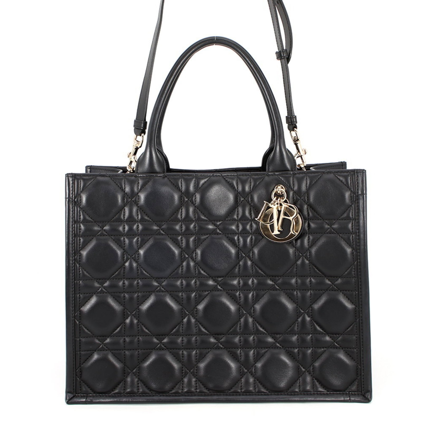 Handbag Tote Leather Dior Christian: Handbag Tote Leather Dior Christian This black leather tote bag from Christian Dior features classic design elements, crafted from high-quality calfskin. Made in Italy, the bag boasts a timeless