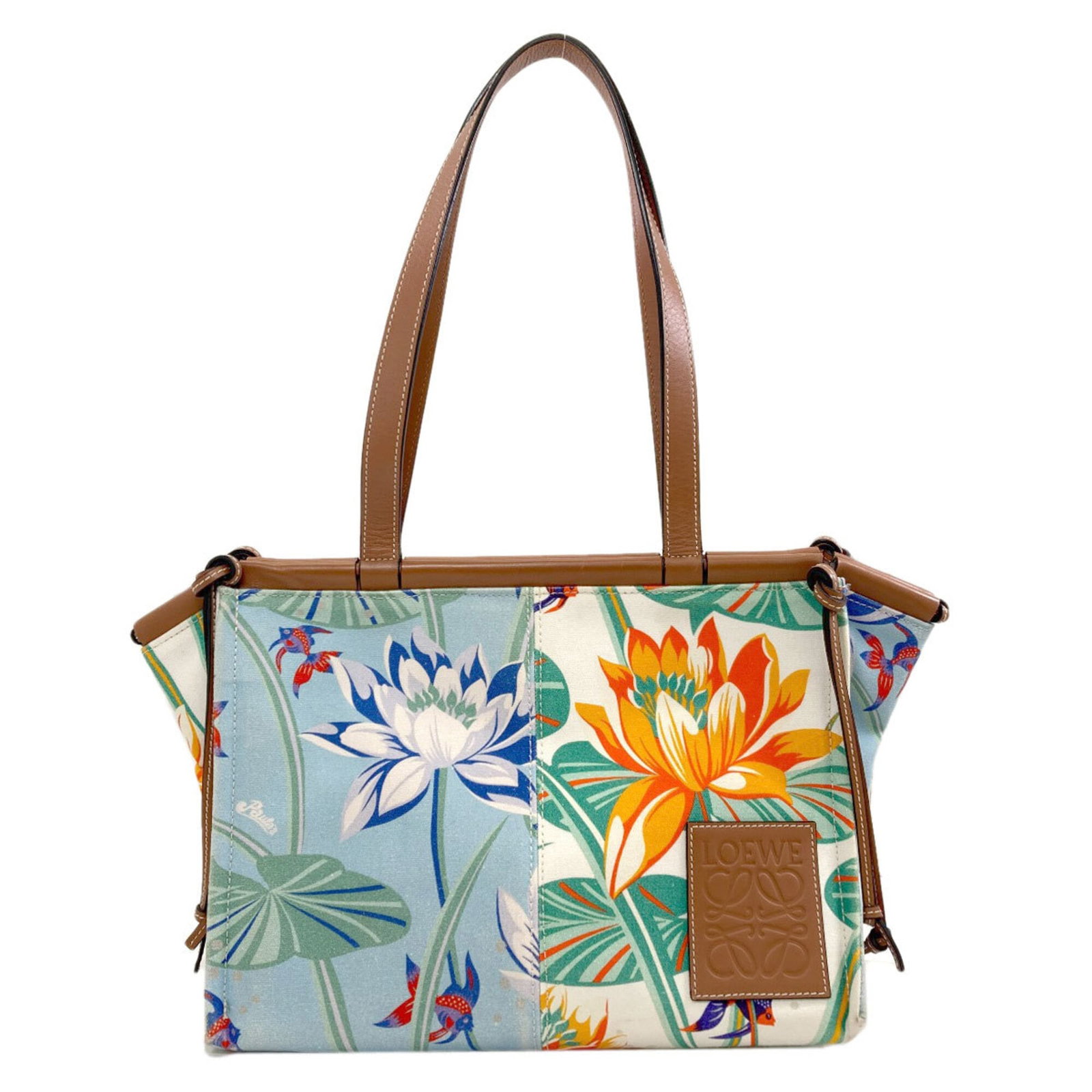 Canvas leather tote bag by Loewe: Canvas leather tote bag by Loewe Canvas leather tote bag by Loewe, available in brown, light blue, and white. This stylish tote features canvas and leather construction, measuring 23cm x 44cm x 15cm.