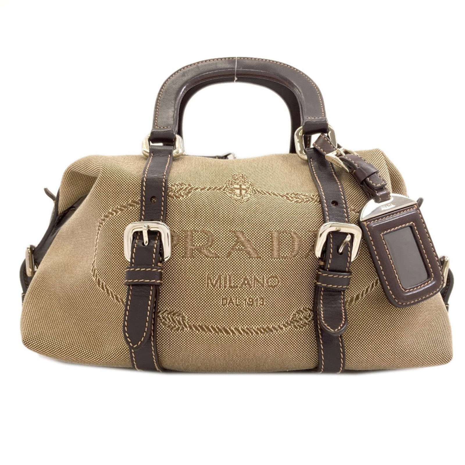 Handbag Canvas by Prada: Handbag Canvas by Prada Canvas by Prada, a brown women's handbag with a size of 16cm x 25cm x 12cm. This canvas bag features the iconic brand's signature style and design elements. The bag bears a