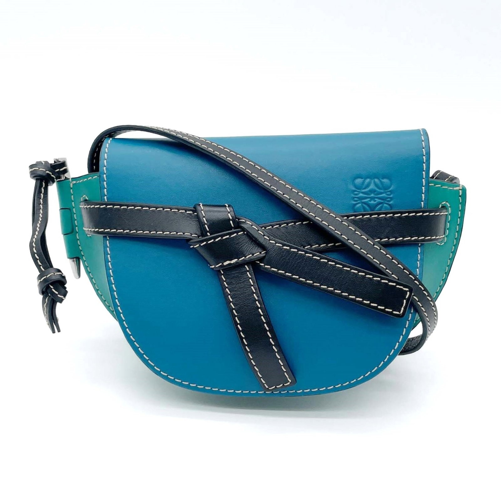 Shoulder Bag Leather Pochette By: Shoulder Bag Leather Pochette By Blue and Green Leather Pochette by Loewe. This shoulder bag features high-quality leather construction, measuring 12cm x 19.5cm x 9cm in size. The pochette bears a