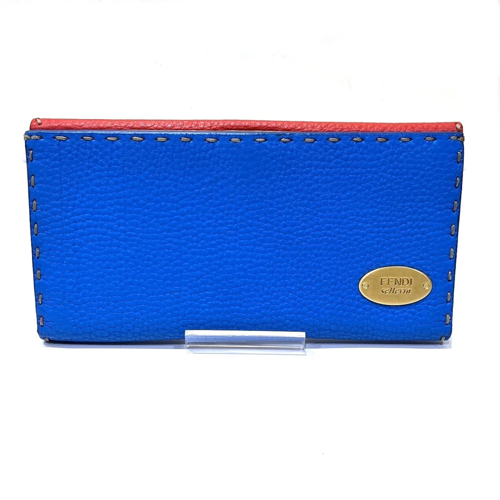FENDI LEATHER WALLET BI FOLD: FENDI LEATHER WALLET BI FOLD Fendi leather wallet bi-fold features bold colors, including blue, red, and yellow. The long design provides ample space for cards and cash, while the compact size makes i