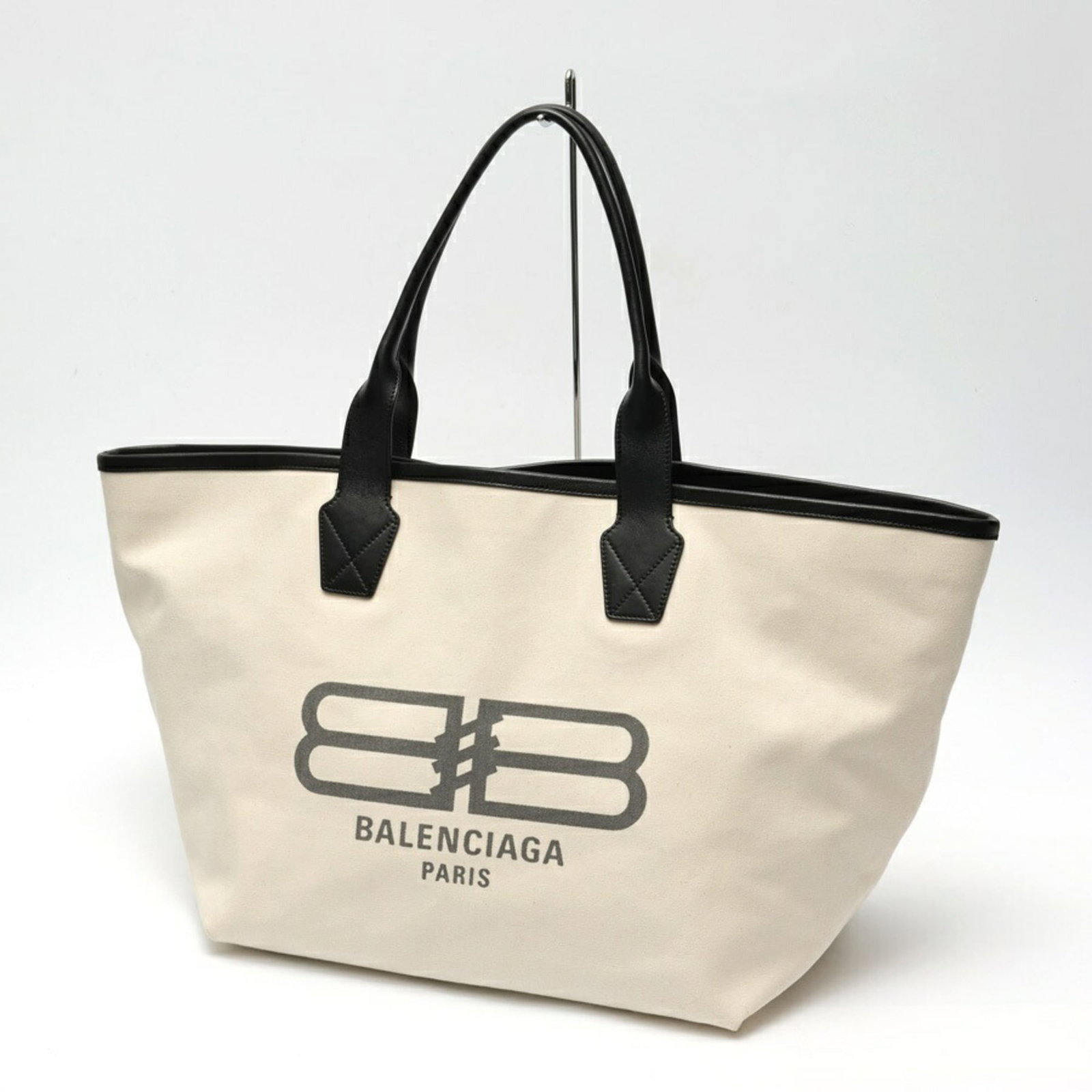 Canvas leather bag tote by Balenciaga: Canvas leather bag tote by Balenciaga Canvas leather bag tote by Balenciaga, featuring canvas and leather construction in black and white colorways. This stylish tote measures 35cm x 63cm x 24cm and