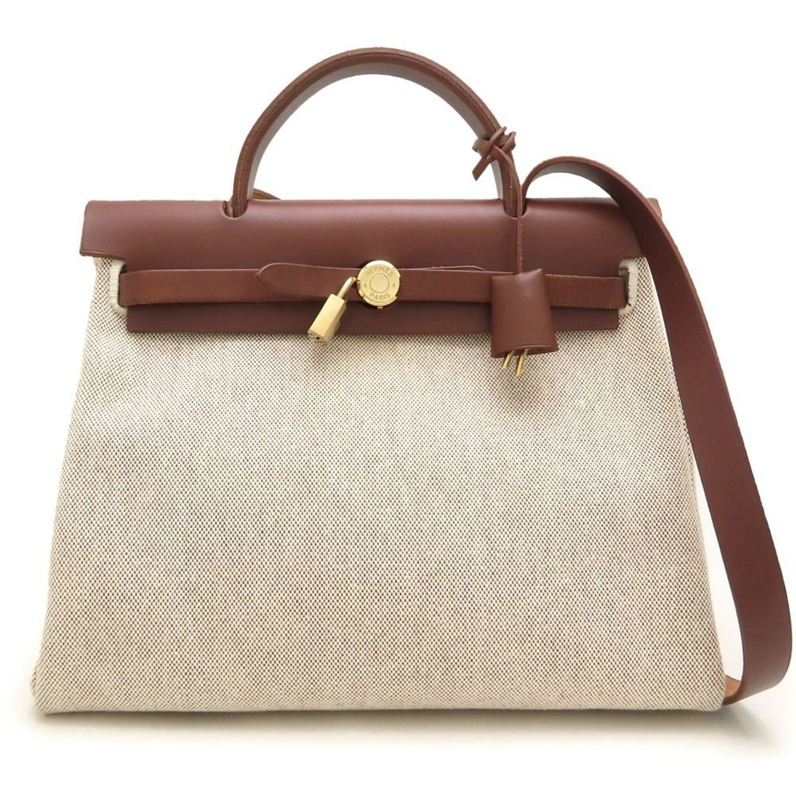Hermes Shoulder Bag Toile Officier Leather: Hermes Shoulder Bag Toile Officier Leather Toile Officier Leather Calfskin Shoulder Bag from Hermes features a timeless beige brown color and gold hardware, while its Toile officier design adds a