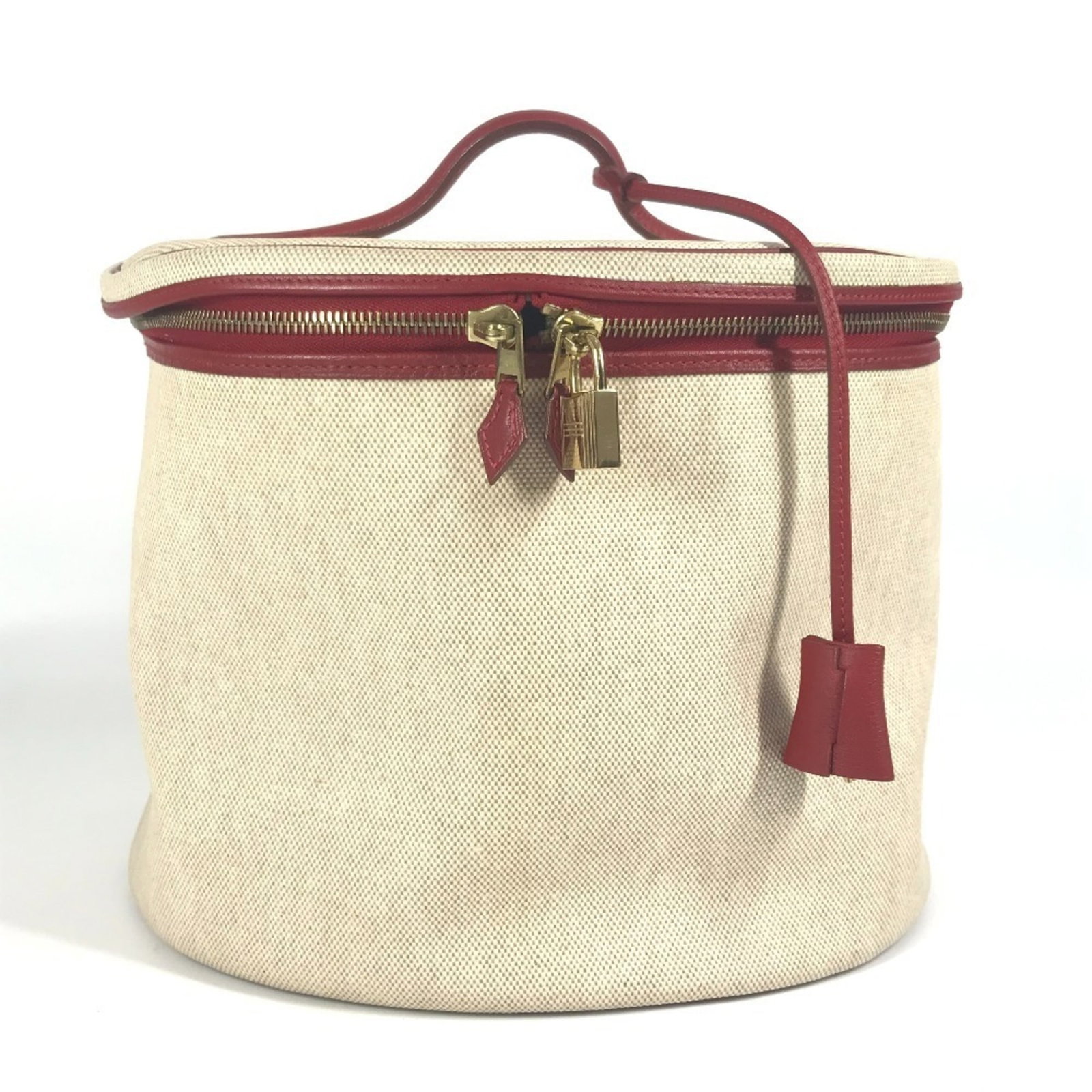 Hermes Handbag Vanity Bag Coated Canvas Leather: Hermes Handbag Vanity Bag Coated Canvas Leather Coated canvas and leather make up the unique exterior of this Hermes Intercity handbag vanity bag, available in beige with red accents. Measuring 21.5cm