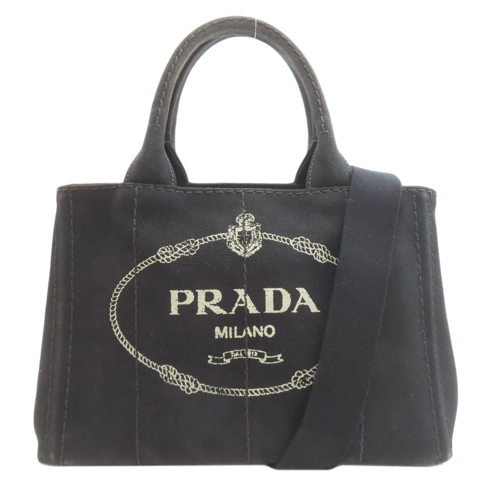 Handbag Canvas by Prada: Handbag Canvas by Prada Canvas by Prada, a sleek and sophisticated black handbag with clean lines and a compact size, measuring 19cm x 28cm x 16cm. This stylish canvas bag features the iconic Prada de
