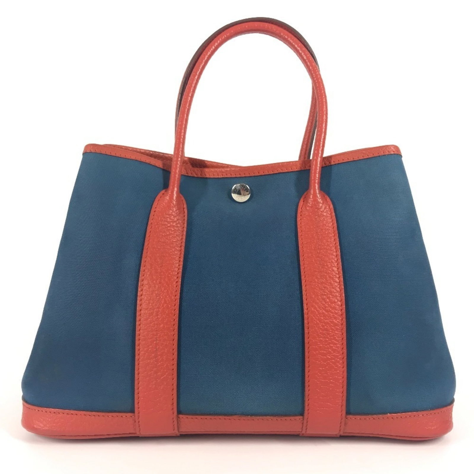 Canvas leather tote bag from Hermes: Canvas leather tote bag from Hermes Canvas and leather blend in a vibrant blue and orange hue, creating a striking tote bag from renowned brand Hermes. Measuring 20cm x 30cm x 13cm, this canvas