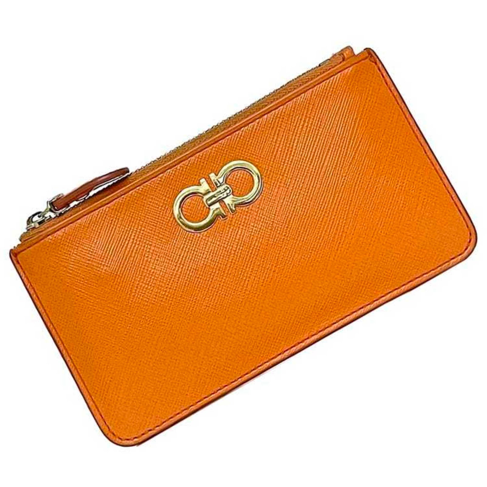 Salvatore Ferragamo Leather Coin Case Purse: Salvatore Ferragamo Leather Coin Case Purse The Salvatore Ferragamo Leather Coin Case Purse boasts vibrant orange leather and elegant design, measuring 8.5cm x 15cm / 3.34'' x 5.9''. This stylish