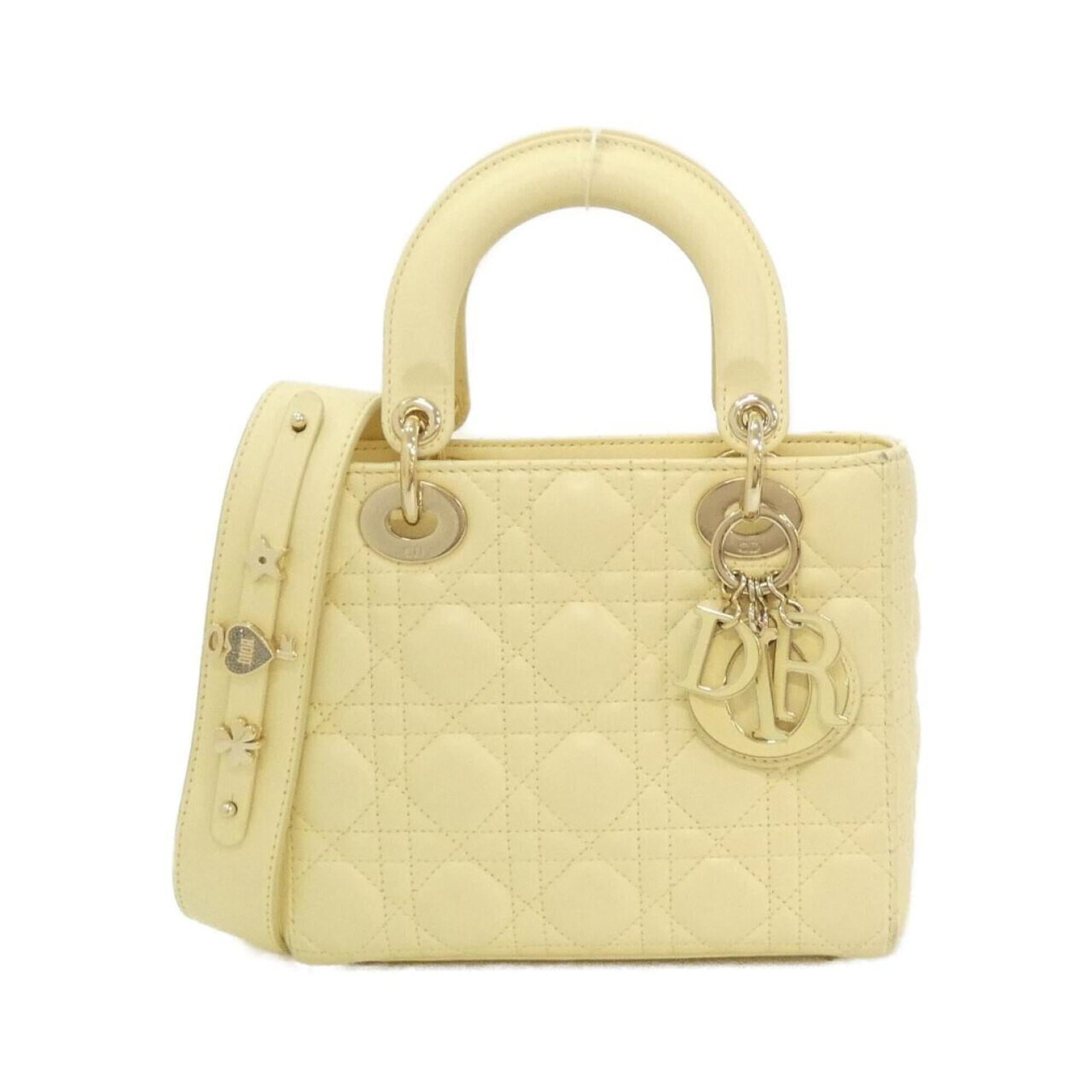 Handbag Christian Dior Leather: Handbag Christian Dior Leather Pale yellow lamb leather handbag from Christian Dior's Lady Dior line, featuring gold hardware and a compact size of 17cm x 20cm x 8cm. This stylish bag showcases the
