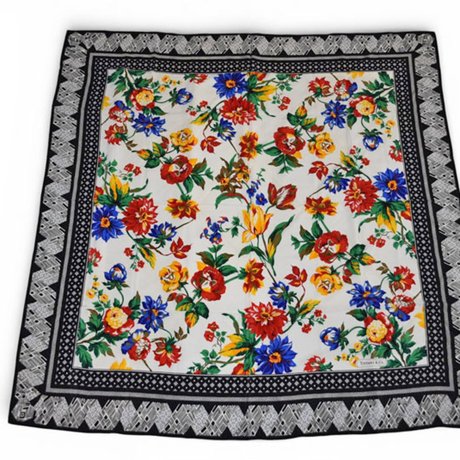 Silk by Tiffany Scarf: Silk by Tiffany Scarf Silk by Tiffany Scarf is crafted from high-quality silk, offering a luxurious feel and appearance. Borne from Italy, this scarf features a striking black and multi-color design