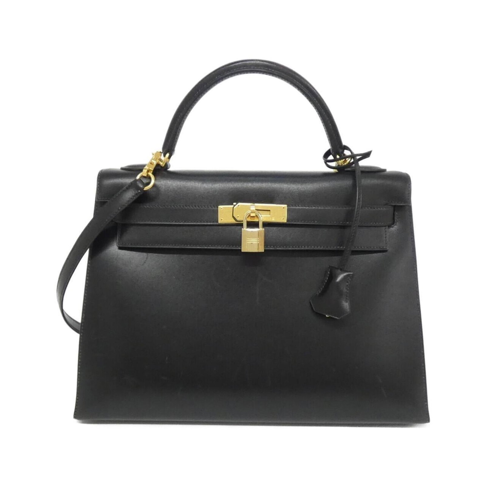 Calf Leather Handbag Hermes: Calf Leather Handbag Hermes Box calf leather construction provides durability and sophistication to this black Calf Leather Handbag from Hermes. The bag's compact size and sleek design make it a