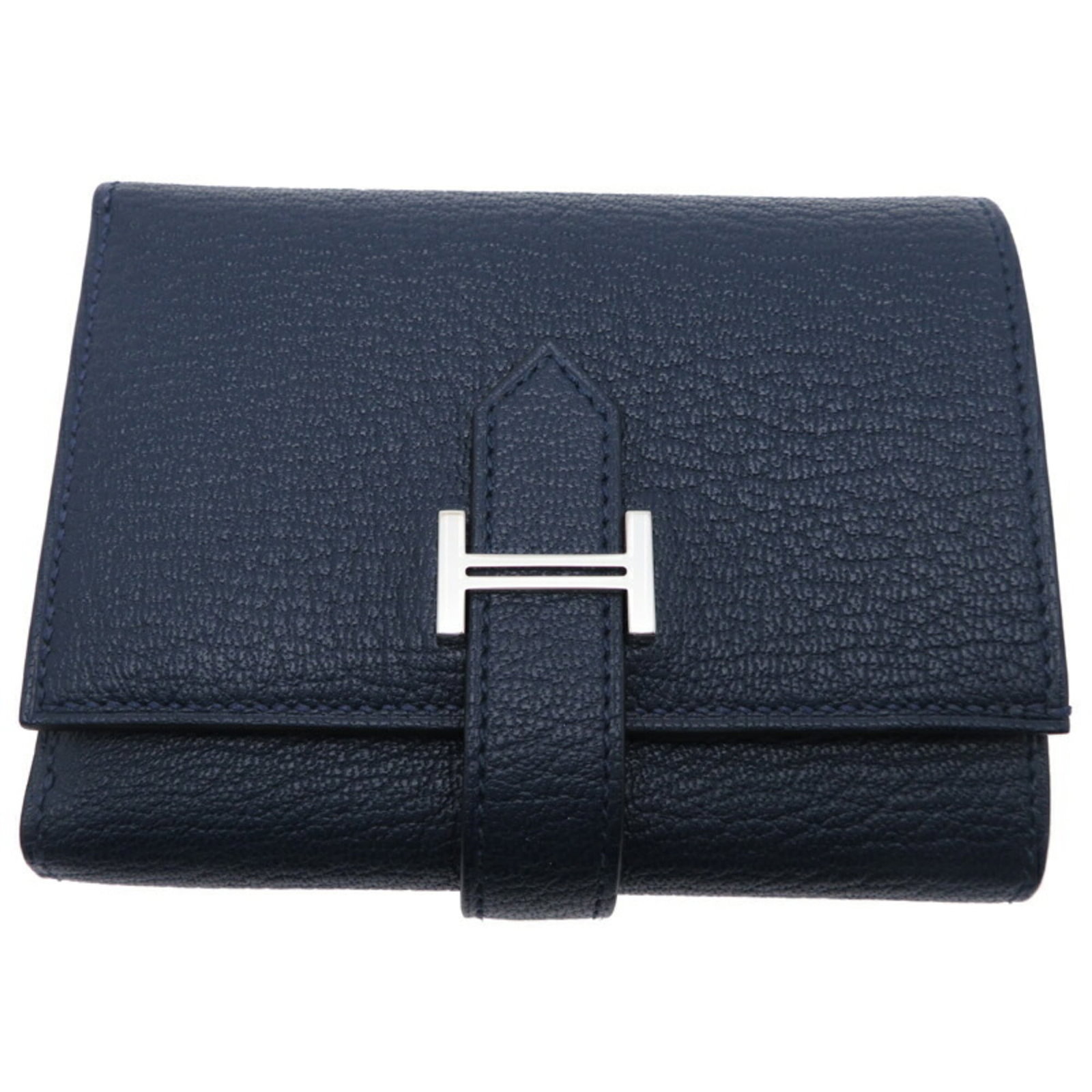Chevre Leather Tri Fold Wallet: Chevre Leather Tri Fold Wallet Navy chevre leather wraps around the tri-fold design, creating a sleek and sophisticated look. The compact size fits neatly in a pocket, while the sturdy construction en