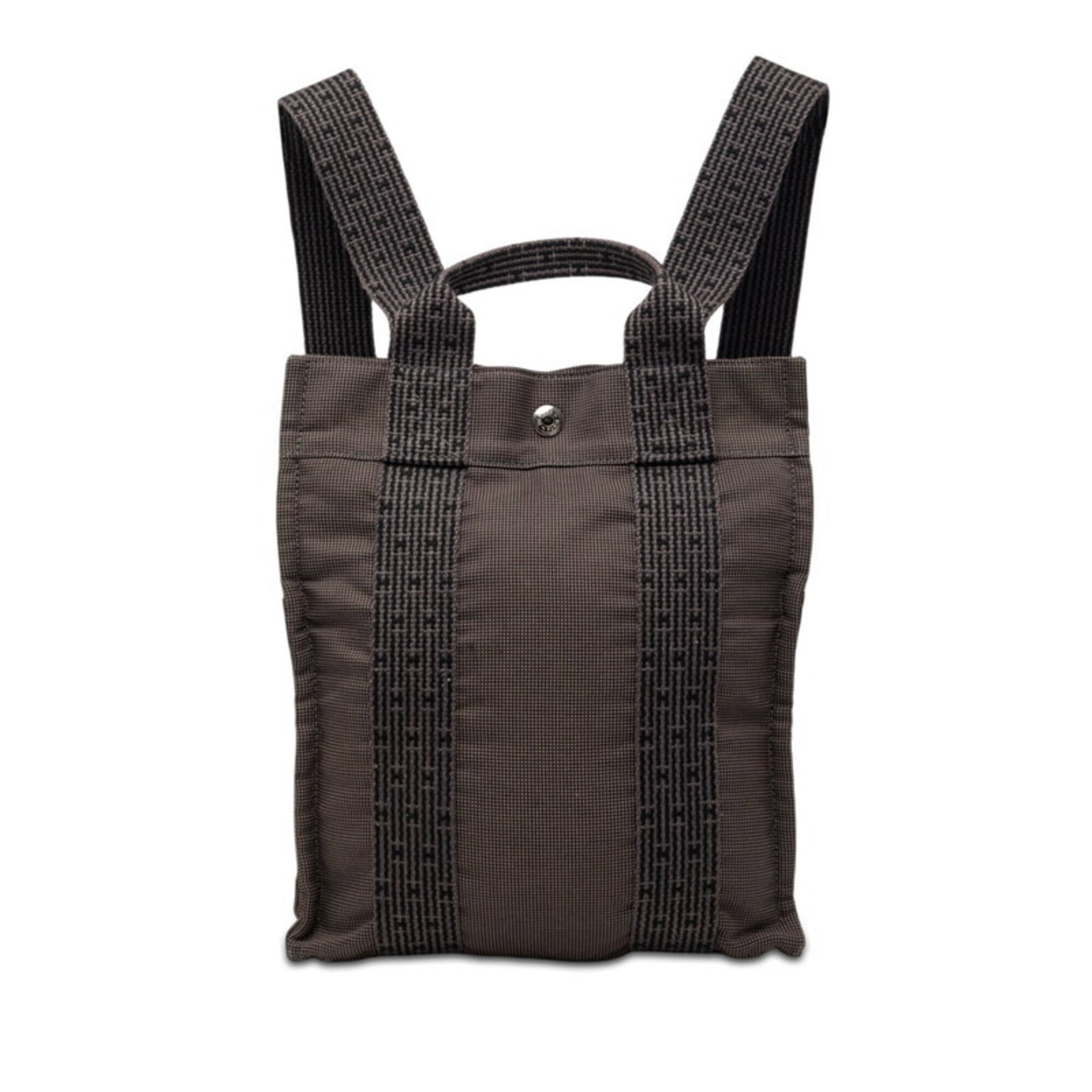 Canvas Backpack by Hermes: Canvas Backpack by Hermes Canvas Backpack by Hermes, featuring a sleek black and gray canvas design with a compact size perfect for daily use. This stylish backpack measures 30cm x 25cm x 6cm and boas