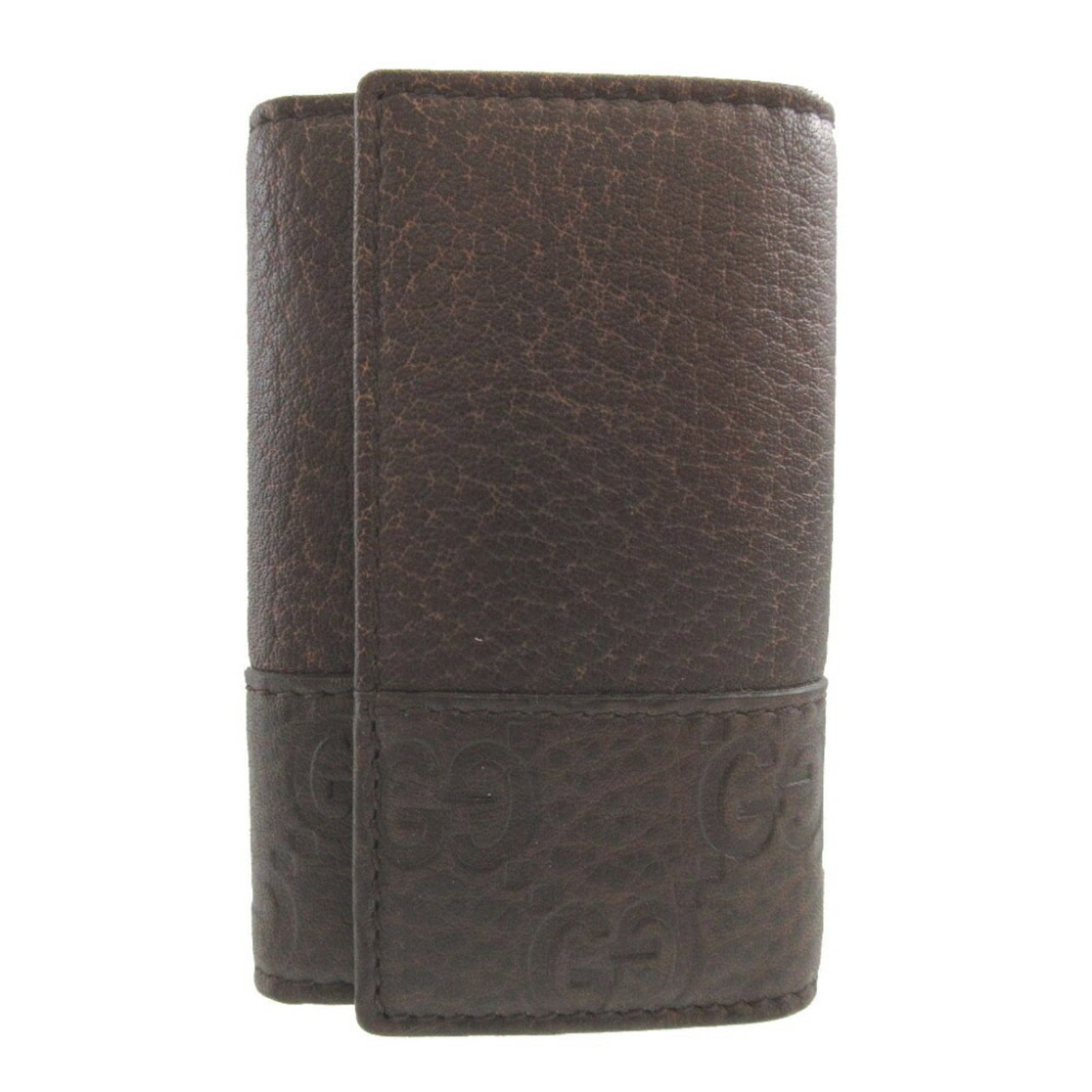 Keycase Leather by Gucci: Keycase Leather by Gucci Keycase Leather by Gucci is a stylish accessory featuring high-quality brown leather construction. Measuring 9.5cm x 6.3cm x 1.5cm, it comes in a compact size perfect for ever