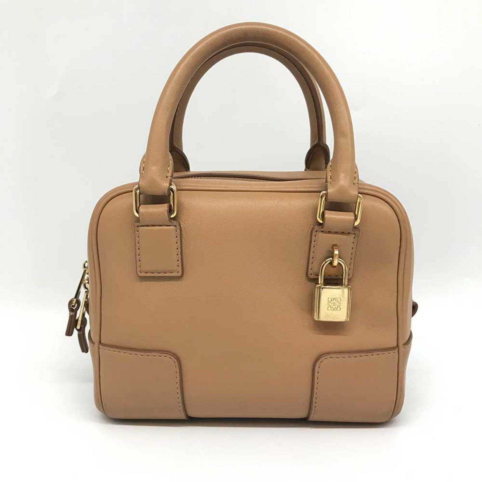 Loewe Handbag Leather: Loewe Handbag Leather Calfskin leather construction provides durability and sophistication to this Beige Loewe Amazona handbag. The bag's classic design and zipper closure make it a timeless accessory