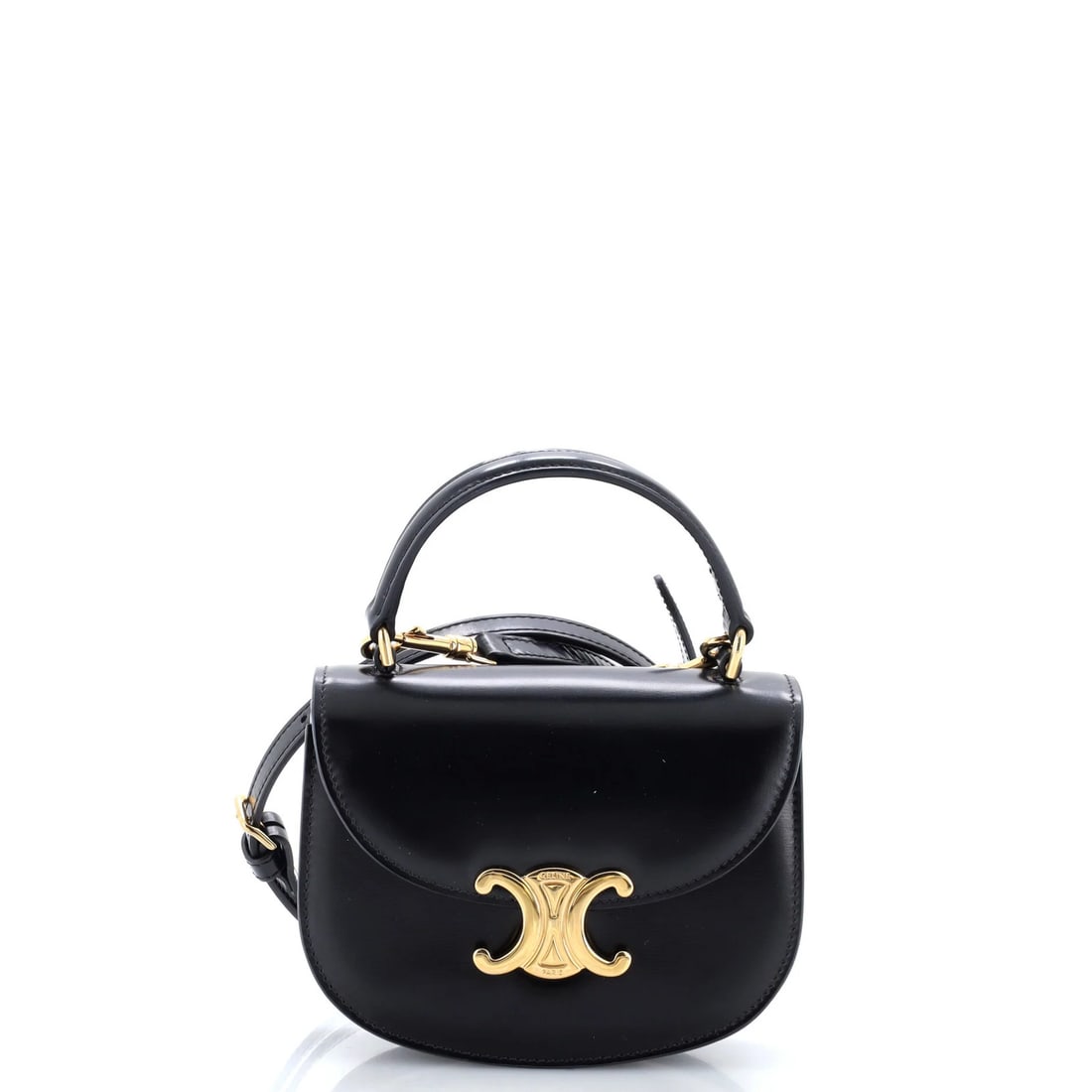 Celine Triomphe Besace Clea Top Handle Flap Bag Leather Mini: Celine Triomphe Besace Clea Top Handle Flap Bag Leather Mini Black leather mini bag with top handle and flap closure, featuring gold hardware. Measuring 5" in height, 6" in width, and 2" in depth, it