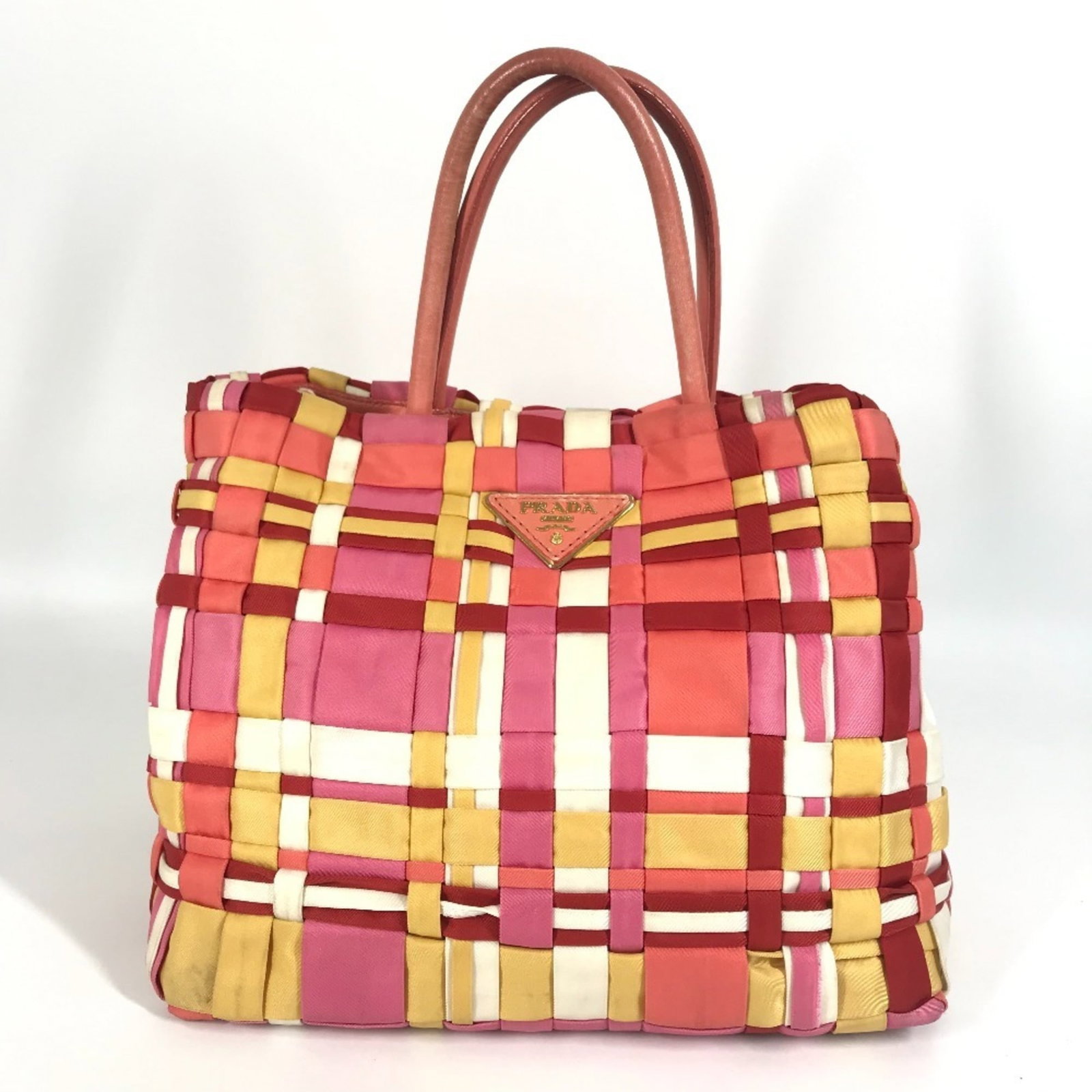 Nylon handbag tote by Prada: Nylon handbag tote by Prada Pink and white nylon Prada tote bag, measuring 25cm x 27cm x 16.5cm, features a simple design with no additional accessories. This nylon handbag tote from Italy's renowned